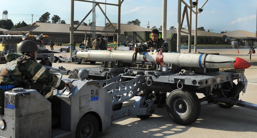 Staff Sgt. Samuel Casares, 55th Fighter Squadron "Shooters" weapons crew chief helps load a missile onto a bomb lift truck during a phase two exercise May 3, 2011. The exercise gave Shaw Airmen the opportunity to train to respond to attacks in simulated wartime conditions.(U.S. Air Force photo/ Airman 1st Class Tabatha L. Duarte)