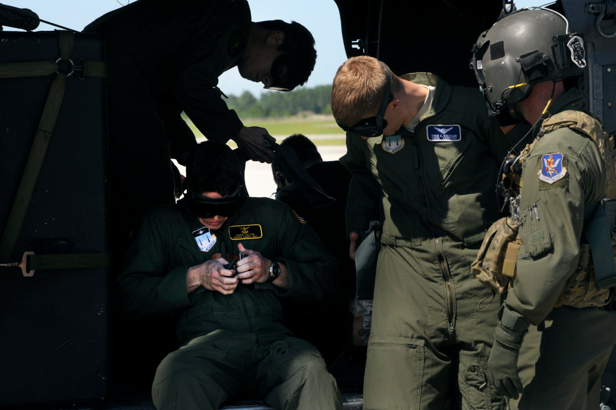 MOODY AIR FORCE BASE, Ga. -- U.S. Air Force Academy cadets fasten their gunner’s belts before taking off for a ride in an HH-60 Pave Hawk April 29. One of the three Pave Hawks that the cadets rode in was piloted by Col. Gary Henderson, 23rd Wing commander. (U.S. Air Force photo/Airman 1st Class Jarrod Grammel)(RELEASED)