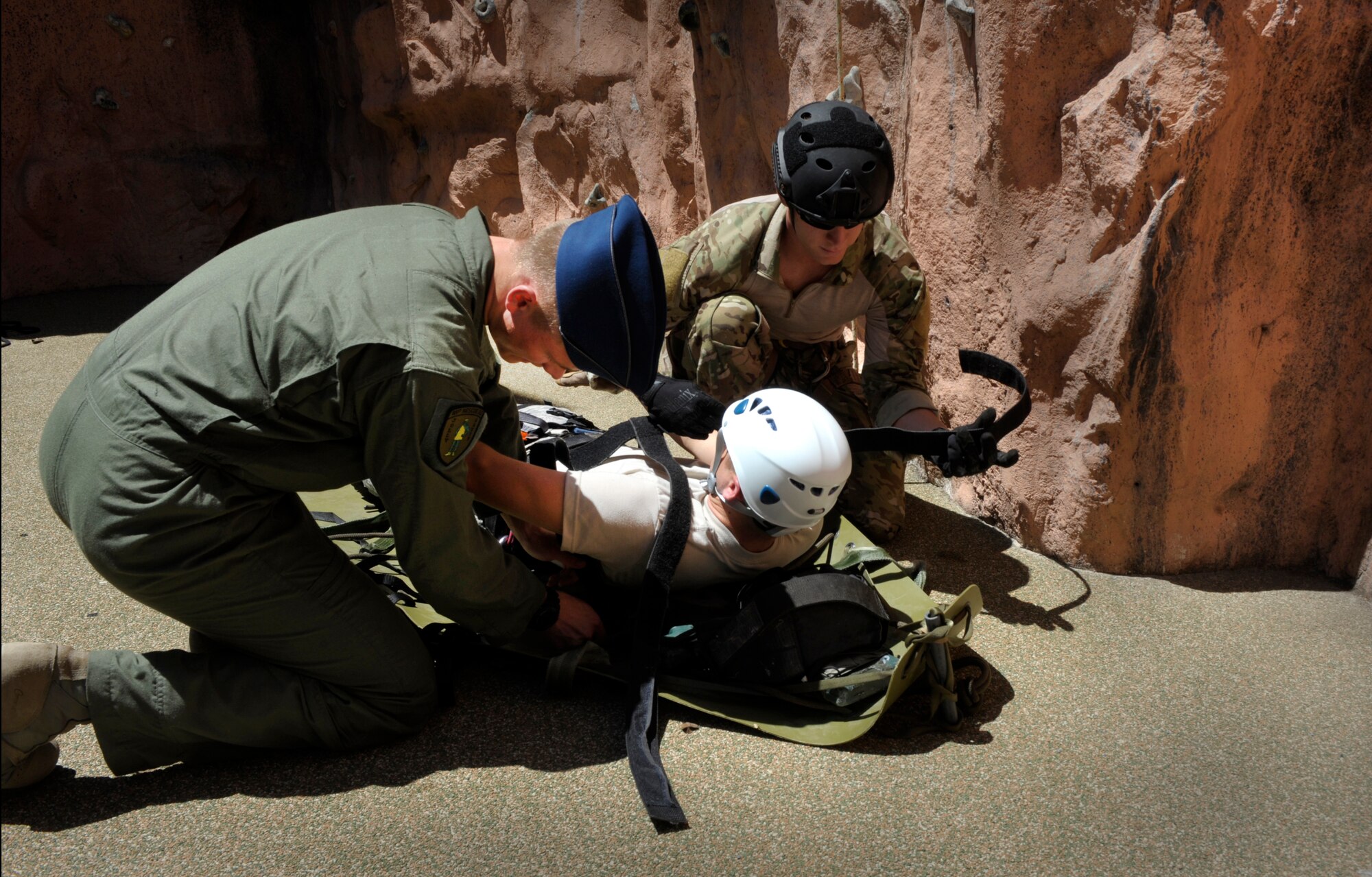 MOODY AIR FORCE BASE, Ga. -- U.S. Air Force Academy Cadet Joseph Eutlus and Senior Airman Dustin Gorski, 38th Rescue Squadron pararescueman, strap a simulated victim into a harness during a base tour April 29. During this portion of the tour, pararescuemen performed a short demonstration, and cadets were able to ask questions about the training and mission of pararescuemen. (U.S. Air Force photo/Airman 1st Class Jarrod Grammel)(RELEASED)