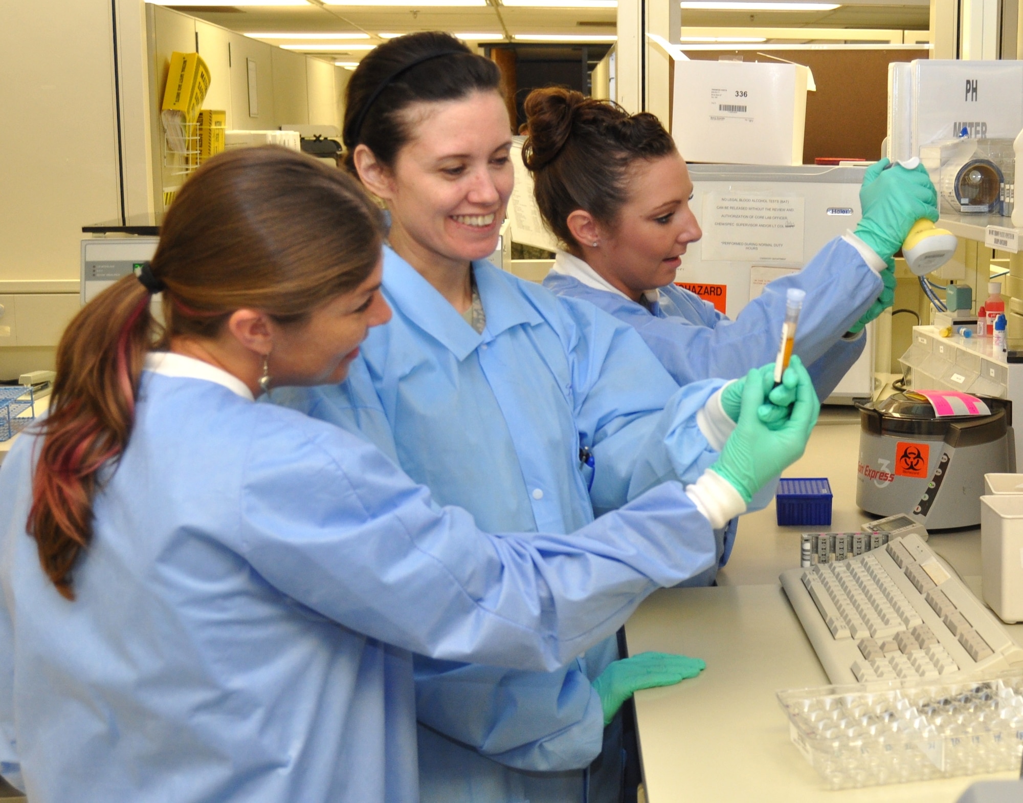 From left, laboratory technicians Tiffany Cook, Staff Sgt. Camelin Riley and Senior
Airman Rebekah Colon pipette samples for the hemoglobin A1C test to determine blood sugar levels in the pathology and clinical laboratory April 21.  (U.S. Air Force photo by Steve Pivnick)