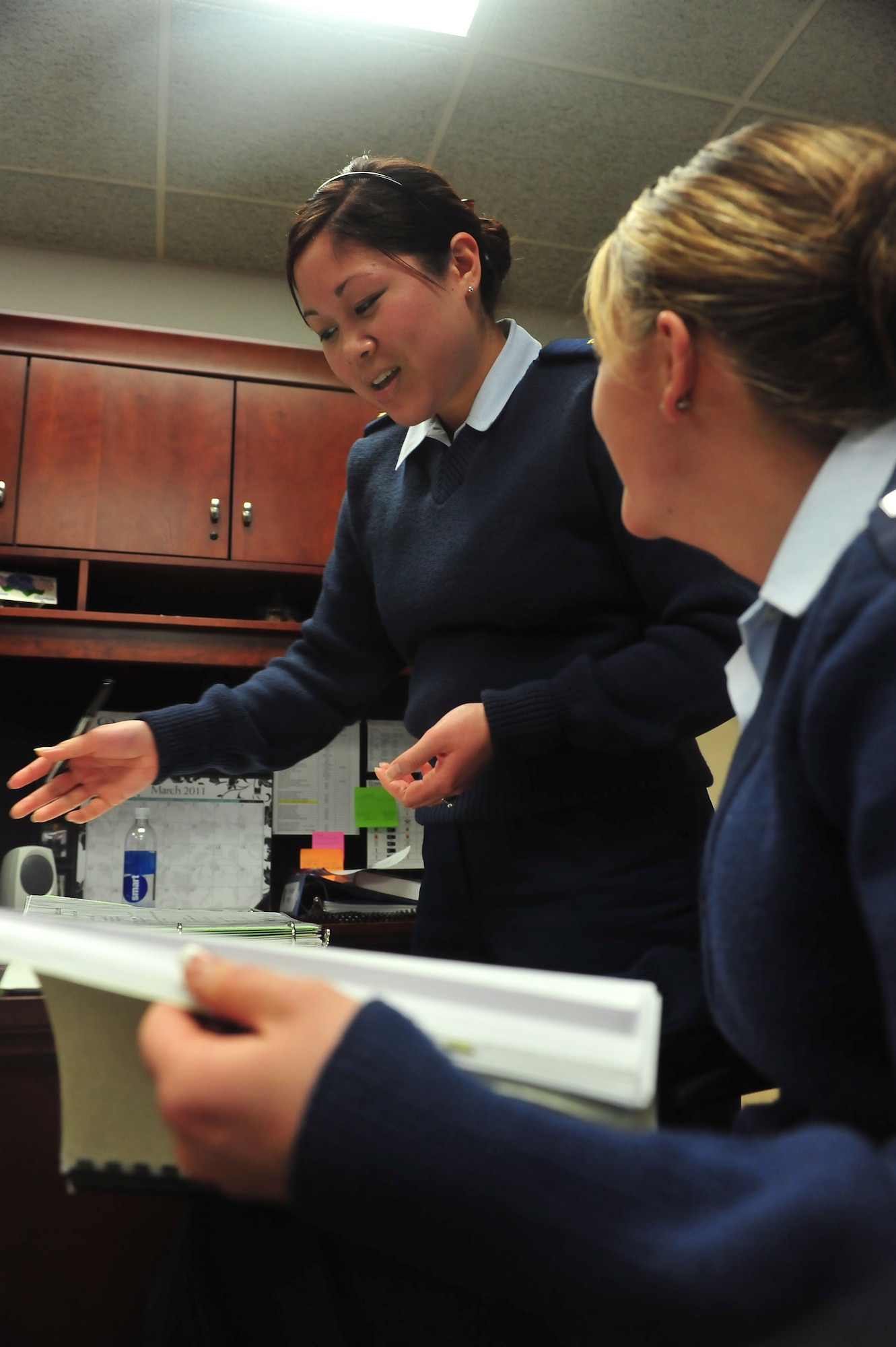 MINOT AIR FORCE BASE -- 2nd Lieutenant Sandra Lee, 5th Force Support Squadron customer support chief and Staff Sgt. Bridget Bollinger, 5th BW protocol personnel, reviews the distinguished visitors’ continuity binder. Protocol personnel are part of a selective, volunteer special duty, assigned to directly support the base commander and vice commander in handling all aspects of distinguished visitor visits, conferences, tours, and social functions initiated within the command.