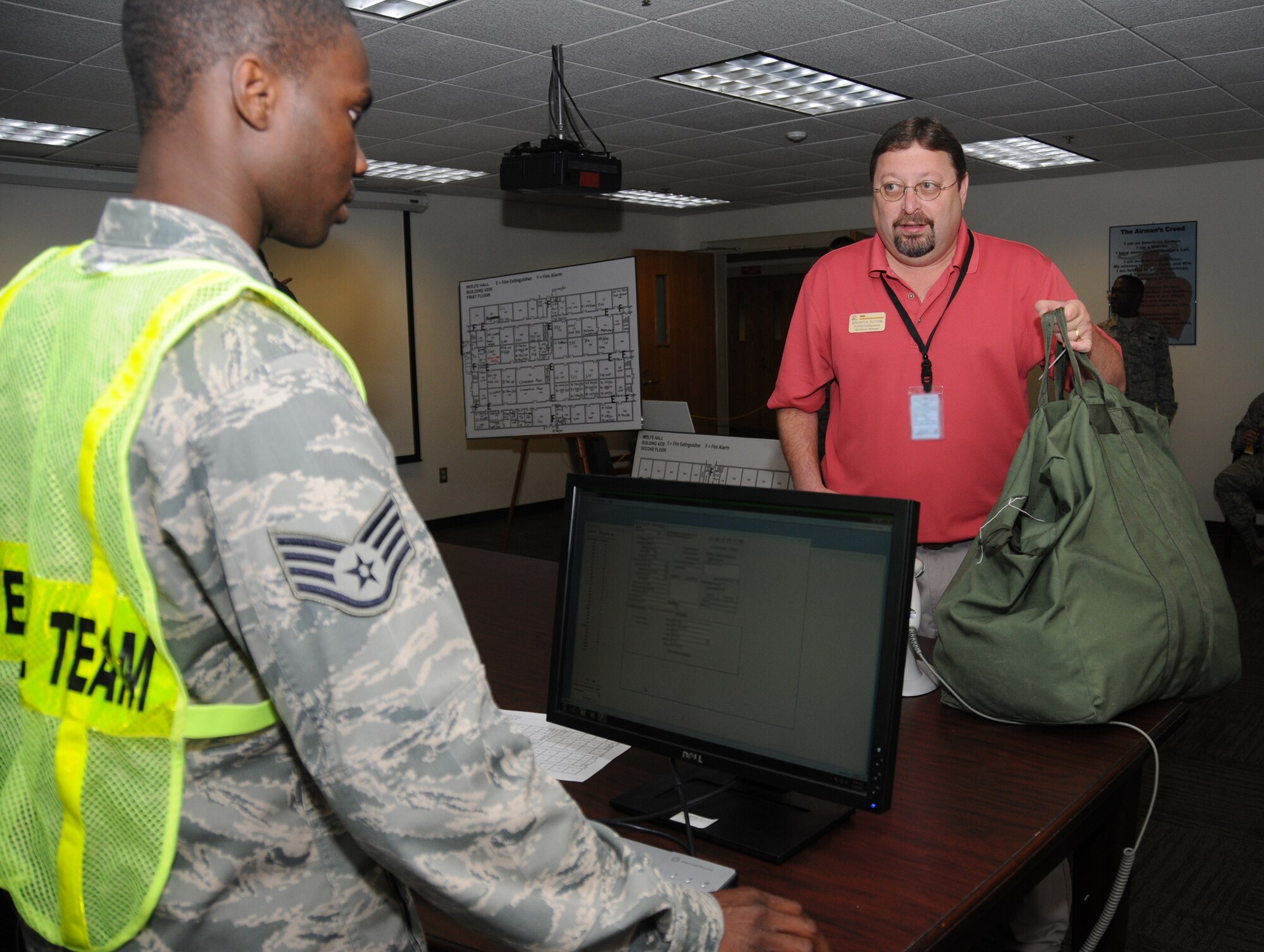 Staff Sgt. Kwadwo Agyen-Frempong, a shelter management team member from the 335th Training Squadron, checks in Johnny Potter, 81st Operations Support Flight, at the Wolfe Hall shelter on the final day of Keesler’s weeklong hurricane exercise, Friday. Keesler’s preparations for hurricane season, which starts June 1 and ends Nov. 30, continue with town hall briefings, 9 a.m. and 5:30 p.m. May 23 and 10:30 a.m. and 5:30 p.m. May 25 at the Bay Breeze Event Center.  (U.S. Air Force photo by Kemberly Groue)