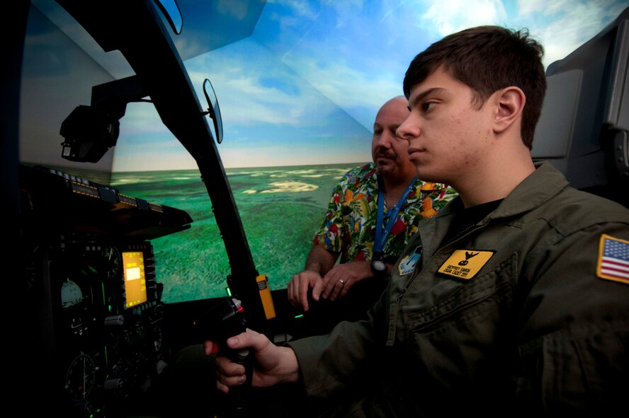 MOODY AIR FORCE BASE, Ga.--Mike O’Dowd, 23rd Operation Support Squadron A-10 simulator instructor pilot, teaches simulator controls to U.S. Air Force Academy cadet Geoffrey Simkin during a base visit April 29. Each year, Moody sponsors a squadron at the Air Force Academy and invites them to tour the base. (U.S. Air Force photo/Airman 1st Class Benjamin Wiseman)(RELEASED)