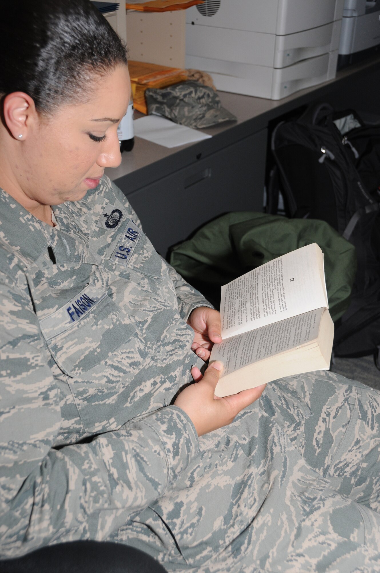 Staff Sgt. Leah Faison, 335th TRS, reads a suspense novel during Friday’s sheltering segment of last week’s hurricane exercise.  (U.S. Air Force photo by Kemberly Groue)