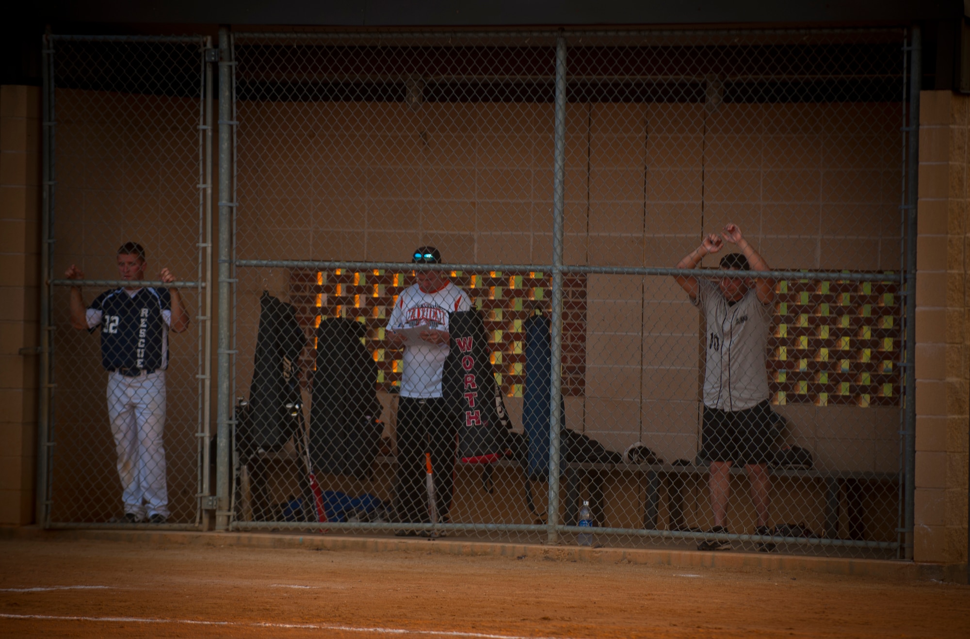 MOODY AIR FORCE BASE, Ga.--Members from the 723rd Aircraft Maintenance Squadron stand in the dugout as they watch fellow teammates attempt to get a three-and-out May 2. Down early in the game, the 723rd AMXS rallied back to gain a come-from-behind victory. (U.S. Air Force photo/Airman 1st Class Joshua Green)(RELEASED)
