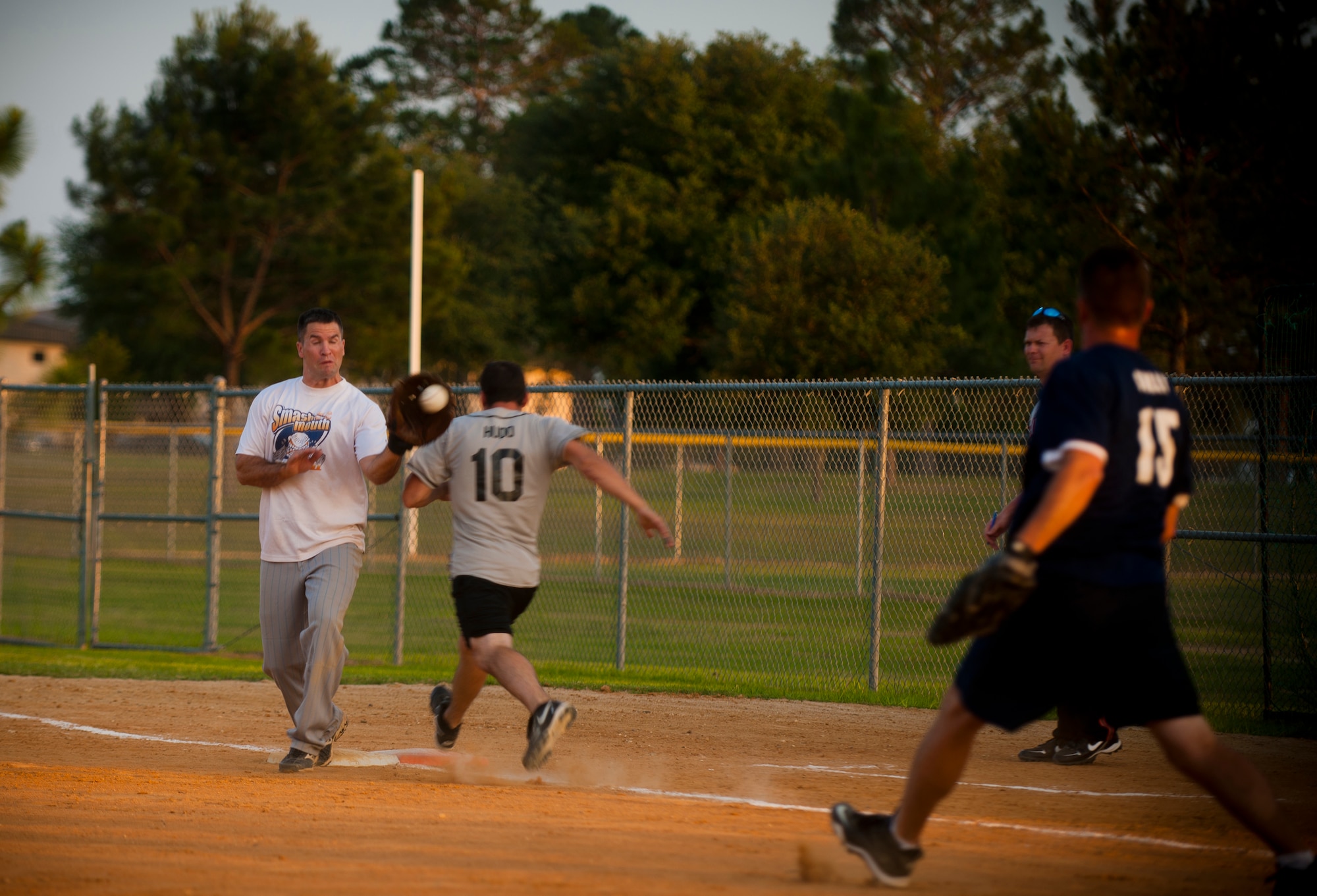 MOODY AIR FORCE BASE, Ga.-- Christopher Daniels, 23rd Medical Group intramural team first baseman, catches a throw from his teammate to make a play at first base May 2. The play slowed down a scoring run by the723rd Aircraft Maintenance Squadron team. (U.S. Air Force photo/Airman 1st Class Joshua Green)(RELEASED)
