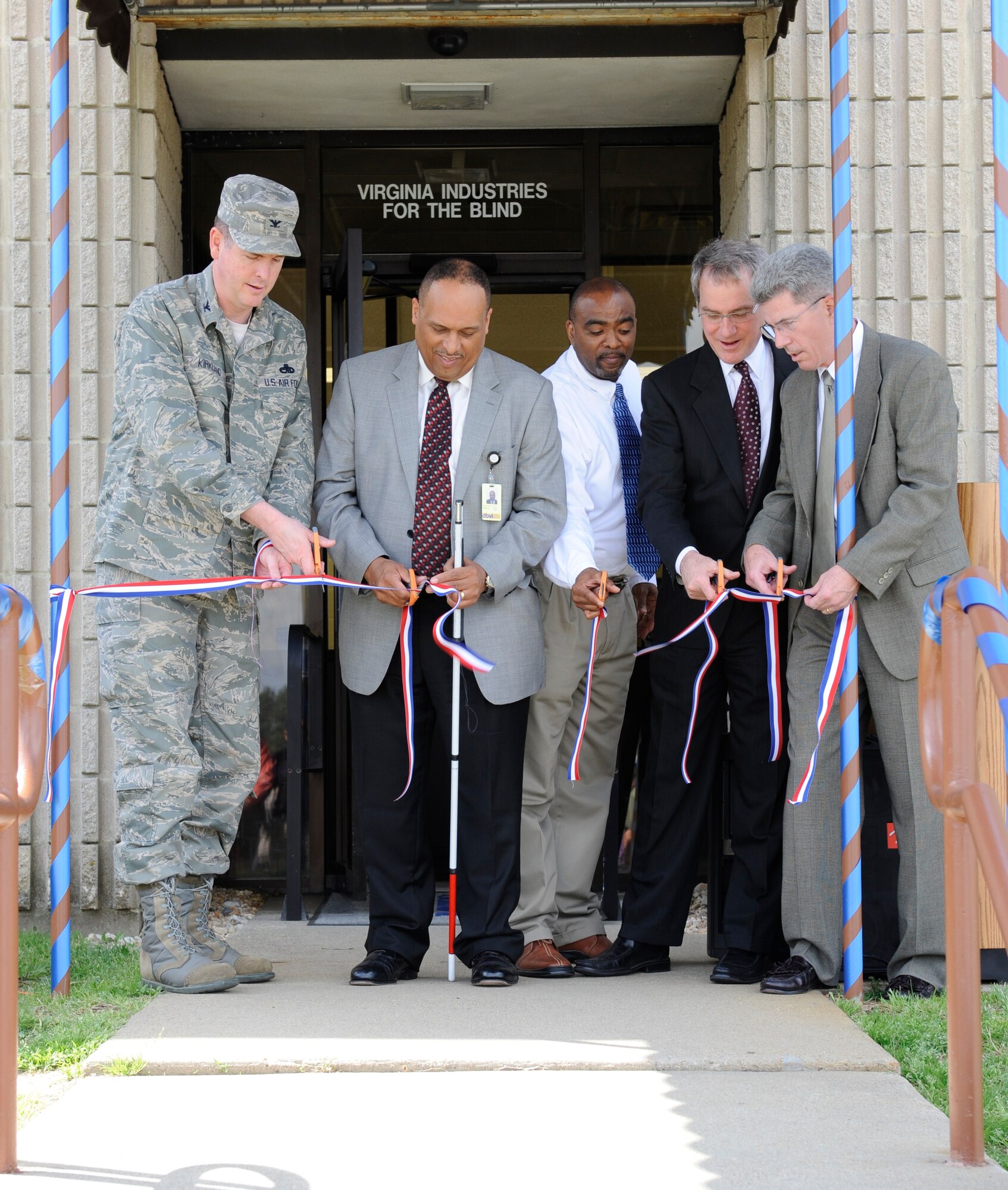 Col. Donald Kirkland, 633d Air Base Wing commander, joins Raymond Hopkins, Virginia Department for the Blind and Vision-impaired commissioner, Heston Highland, Langley Office Supply and Individual Equipment Element Store manager, Steve Heinecke, vice president for product and online marketing for the National Industries for the Blind, and Jim Meehan, General Manager of the Virginia Industries for the Blind, in cutting the ribbon during the grand reopening of the VIB Office Supply Store at Langley Air Force Base, Va., April 26. The store reopened after four months of renovations. VIB provides training and employment opportunities for employees who are blind or vision-impaired, and began its partnership with Langley AFB in 2000 when it assumed operation of the Individual Equipment Element and, shortly after, the office supply store. (Coutesy photo/Heston Highland)