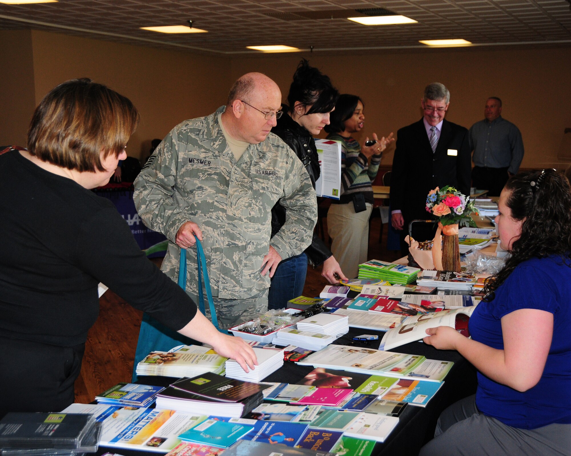 NIAGARA FALLS AIR RESERVE STATION, N.Y- Technical Sgt. Joe Mesmer (center) 914th Airlift Wing chief of personnel relocations is among many members who took advantage to talk with Ms. Melissa Richardson from Military One Source and other representatives who were in attendance at the Falcon Club during public service recognition week. (U.S. Air Force Reserve photo by Peter Borys)