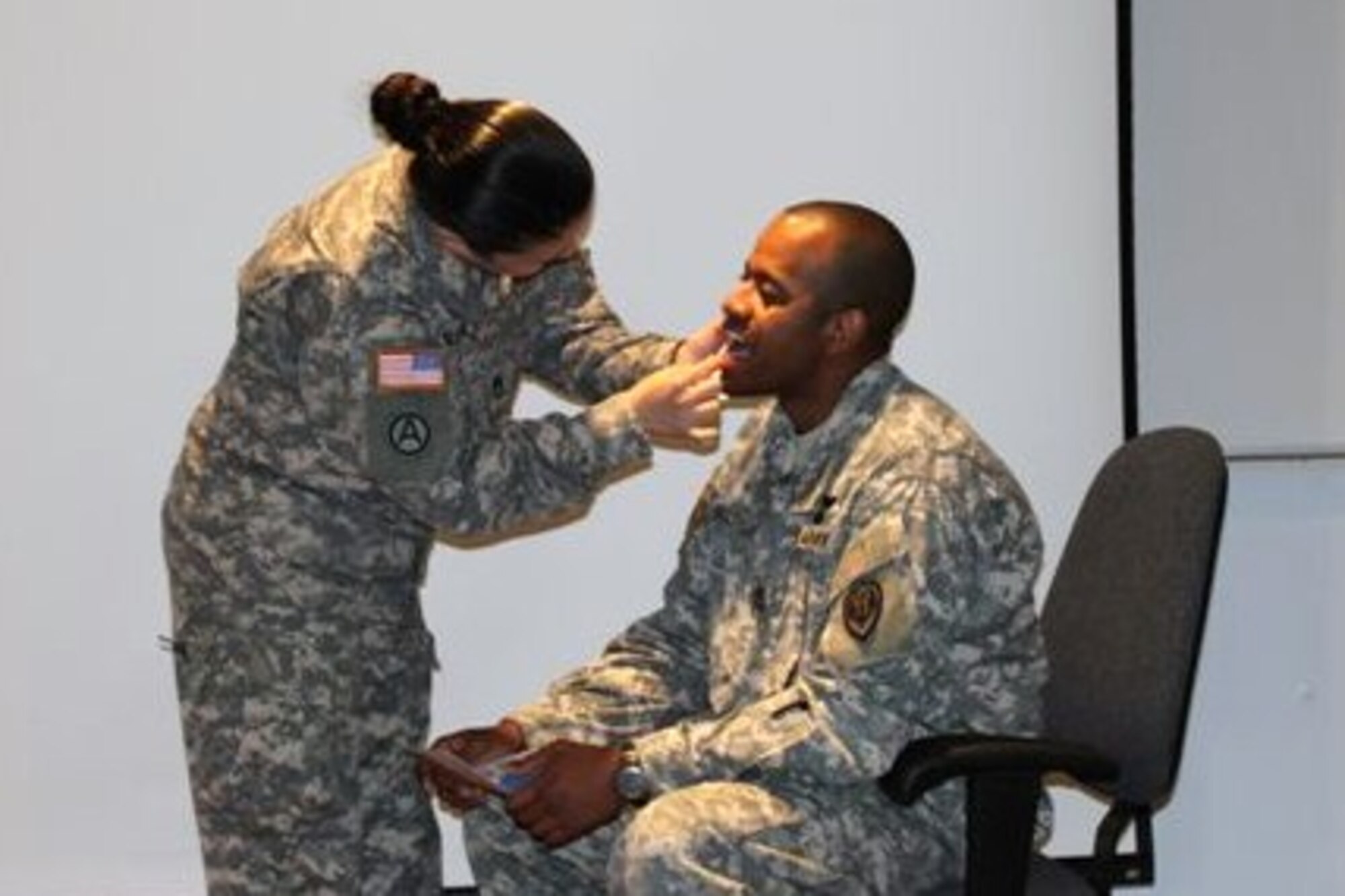 Sgt. 1st Class Jennifer Williams, Army Training Support Center instructor, gathers cheek swab samples from Sgt. 1st Class Torres Bultron, Army Aviation Logistics School instructor, during a bone marrow donation presentation at Hunter Hall at Fort Eustis, Va., April 20. The registration drives, scheduled for May 12 at Fort Eustis and Langley Air Force Base, will enroll eligible donors into the C.W. Bill Young Department of Defense Marrow Donor Program, established to recruit volunteer marrow donors from active-duty military, immediate family members, civil service employees, Coast Guardsmen, National Guardsmen, Reservists and retirees. (Courtesy photo/Sgt. 1st Class Jennifer Williams)