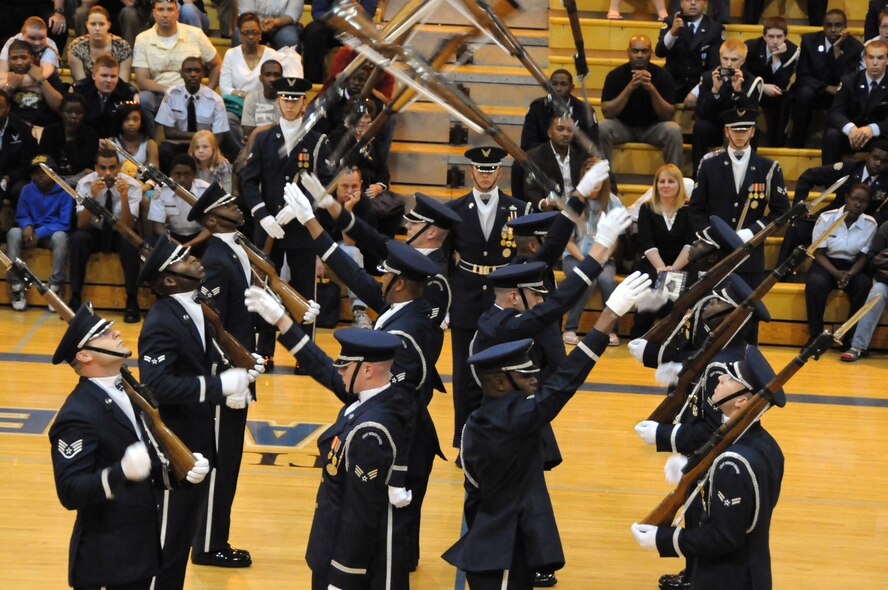 The U.S. Air Force Honor Guard drill team performs throw-backs April 30, 2011 at the Virginia Air Force Association's JROTC drill competition, Atlee High School, Mechanicsville, Va. Throw-backs are a drill movement where the team blindly throws their rifles back to the Airmen behind them. (U.S. Air Force photo by Airman 1st Class Tabitha N. Haynes)