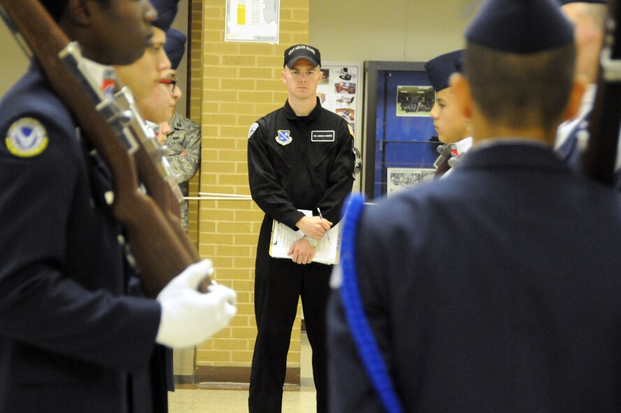 Airman 1st Class Andrew Winders, member of the U.S. Air Force Honor Guard Drill Team, observes the JROTC cadet’s armed drill portion of the Virginia Air Force Association's JROTC drill competition April 30, 2011 at Atlee High School, Mechanicsville, Va. (U.S. Air Force photo by Airman 1st Class Tabitha N. Haynes)