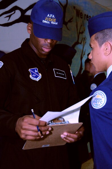 Airman 1st Class Jimmie Pryor, member of the U.S. Air Force Honor Guard drill team, searches for a memory question while judging the JROTC cadet’s military bearing during an open-ranks inspection April 30, 2011 at the Virginia Air Force Association's JROTC drill competition, Atlee High School, Mechanicsville, Va. (U.S. Air Force photo by Airman 1st Class Tabitha N. Haynes)