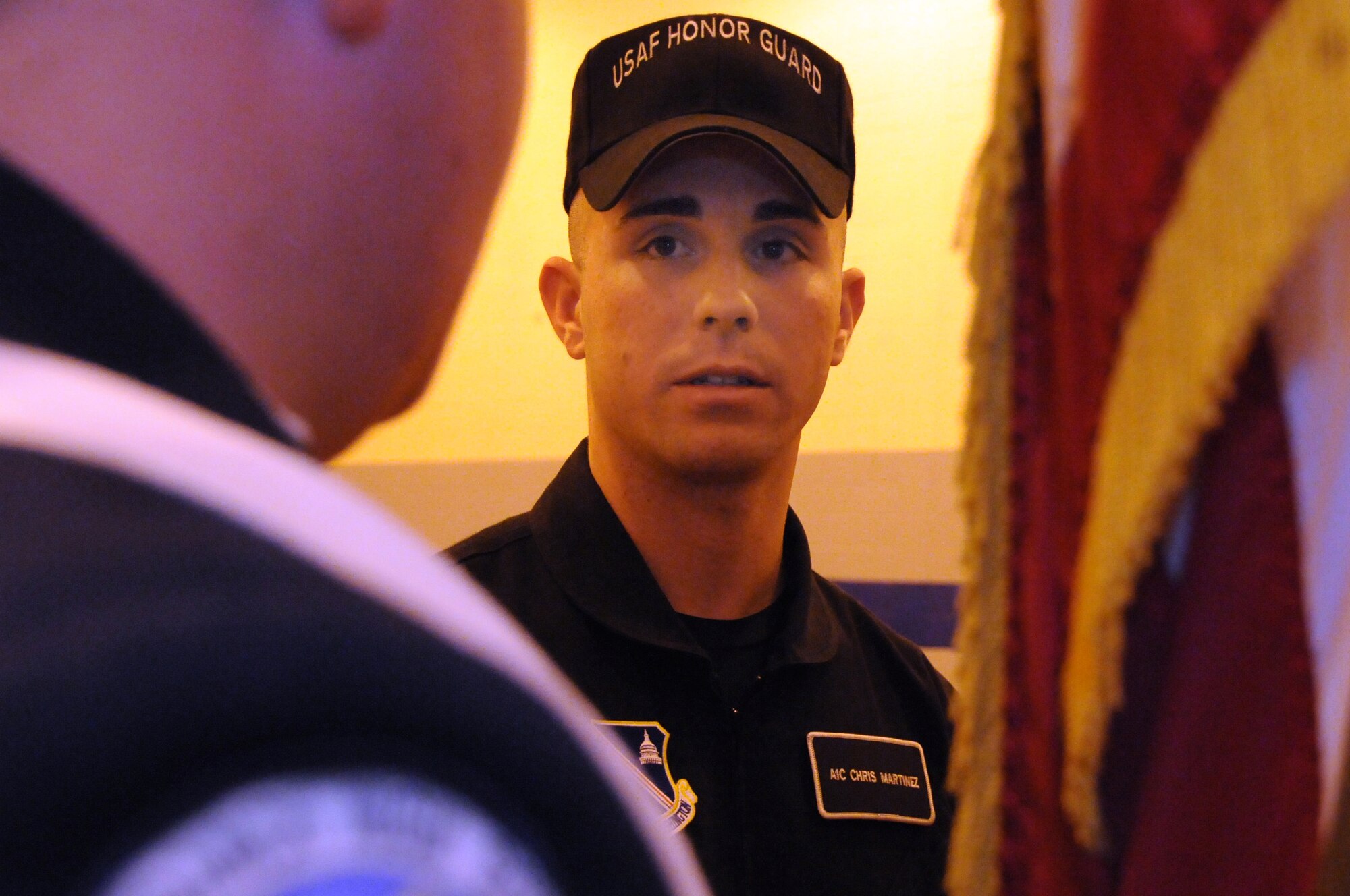 Airman 1st Class Christopher Martinez, member of the U.S. Air Force Honor Guard drill team, speaks encouragement to the JROTC cadet April 30, 2011 at the Virginia Air Force Association's JROTC drill competition, Atlee High School, Mechanicsville, Va. (U.S. Air Force photo by Airman 1st Class Tabitha N. Haynes)