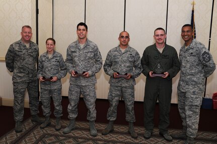 Col. Erik Hansen (left) and Chief Master Sgt. Terrence Greene (right) present Airman 1st Class Ellen Gruesen, Tech. Sgt. Aaron Bermudez, Staff Sgt. Michael Howell and Staff Sgt. Michael Folk the Diamond Sharp award during a ceremony at the Charleston Club May 3. Colonel Hansen is the 437th Airlift Wing commander, Chief Greene is the 437 AW command chief, Airman Gruesen is from the 437th Aircraft Maintenance Squadron, Sergeant Bermudez is from the 437th Maintenance Operations Squadron, Sergeant Howell is from the 437th Aerial Port Squadron and Sergeant Folk is from the 15th Airlift Squadron. Diamond Sharp awardees are Airmen chosen by their first sergeants for their excellent performance. (U.S. Air Force photo/