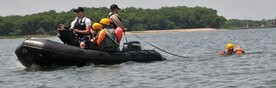 An Airman participating in a water survival training course is being pulled by a Zodiac inflatable boat May 2, 2011, at the Charleston Harbor (S.C.) to experience the feeling of being dragged by a parachute. The course must be taken every three years by every pilot, crew member and Airman who is on flight status in order to stay flight qualified. The course is held during the warmer spring and summer months and tests the student’s abilities to release a parachute in the water, board a life raft and come out from under a parachute. (U.S. Air Force Photo /Airman 1st Class Jared Trimarchi)