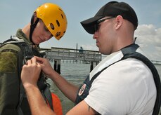 Senior Airman Carter Matthew (right), a survival, evasion, resistance and escape augmentee, tightens the harness on a student during a water survival training course May 2, 2011, at the Charleston Harbor (S.C.). Every pilot, crew chief and Airmen who are on flight status from Joint Base Charleston must take the water survival training course every three years to maintain their flying status. Airman Matthew is from the 628th Communications Squadron. (U.S. Air Force Photo/Airman 1st Class Jared Trimarchi) 

