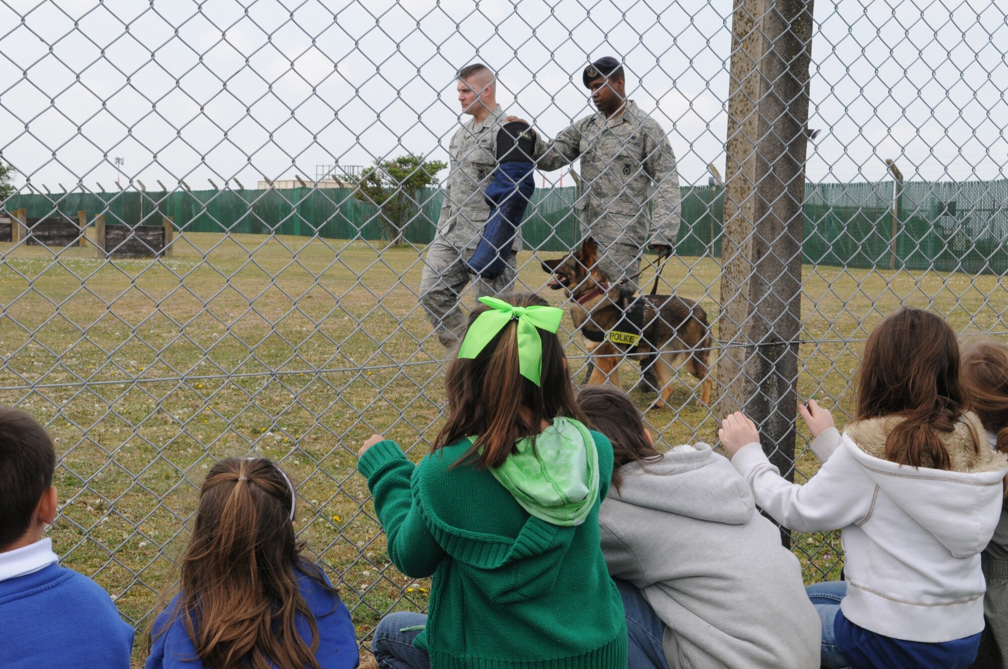 RAF MILDENHALL, England -- Children participating in RAF Mildenhall's Job Shadow Day here watch a military working dog demonstration April 28, 2011. The intended goal was to inspire kids to explore future career options. (U.S. Air Force photo/Staff Sgt. Thomas Trower)