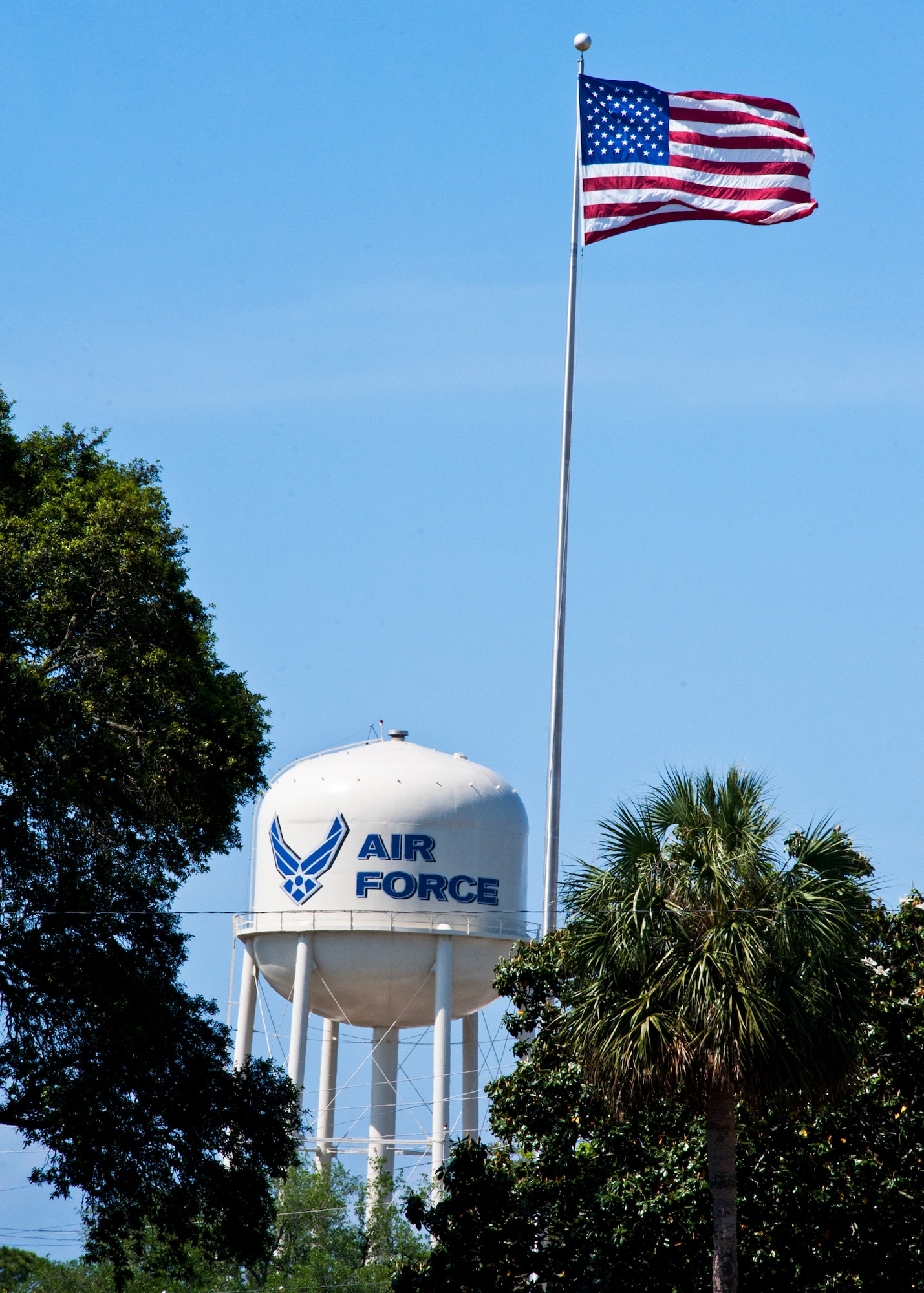 The American flag flies high above the Air Armament Center headquarters at Eglin Air Force Base, Fla.  Eglin personnel and visitors are reminded to pay respect to the flag during Reveille at 7:30 a.m. and Retreat at 5 p.m. each day.  (U.S. Air Force photo/Samuel King Jr.)