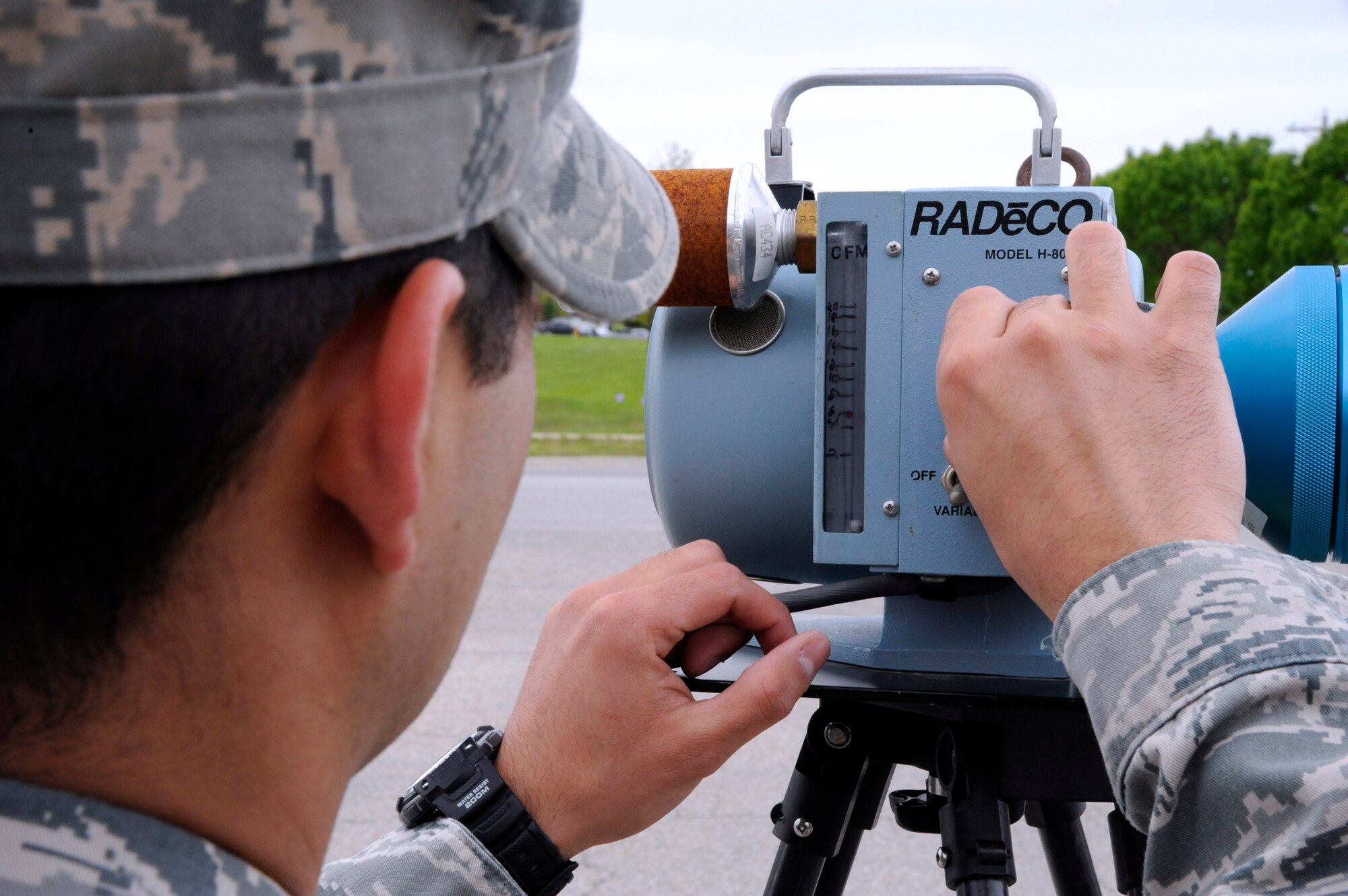WHITEMAN AIR FORCE BASE, Mo. -- Staff Sgt. Edwin Origel, 509th Medical Operations Squadron bioenvironmental technician, adjusts air monitoring equipment to sample alpha particles in the air here May 2, 2011. These samples are part of a study to see how far radiation has reached from the Fukishima Dai-ichi nuclear plant melt down. All readings have been normal and radiation spikes are not expected, however, in support of the study bioenvironmental testing will continue until further notice. (U.S. Air Force photo by Airman 1st Class Cody H. Ramirez)