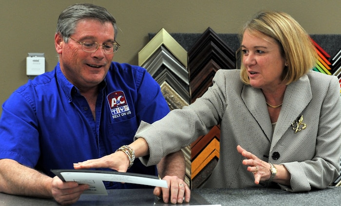 Tom Kiernan, Arts and Crafts director, explains how to prepare a double matt for a custom frame to Julie Kowalski April 25 on a tour of his facility during her orientation tour at Malmstrom. (U.S. Air Force photo/John Turner)