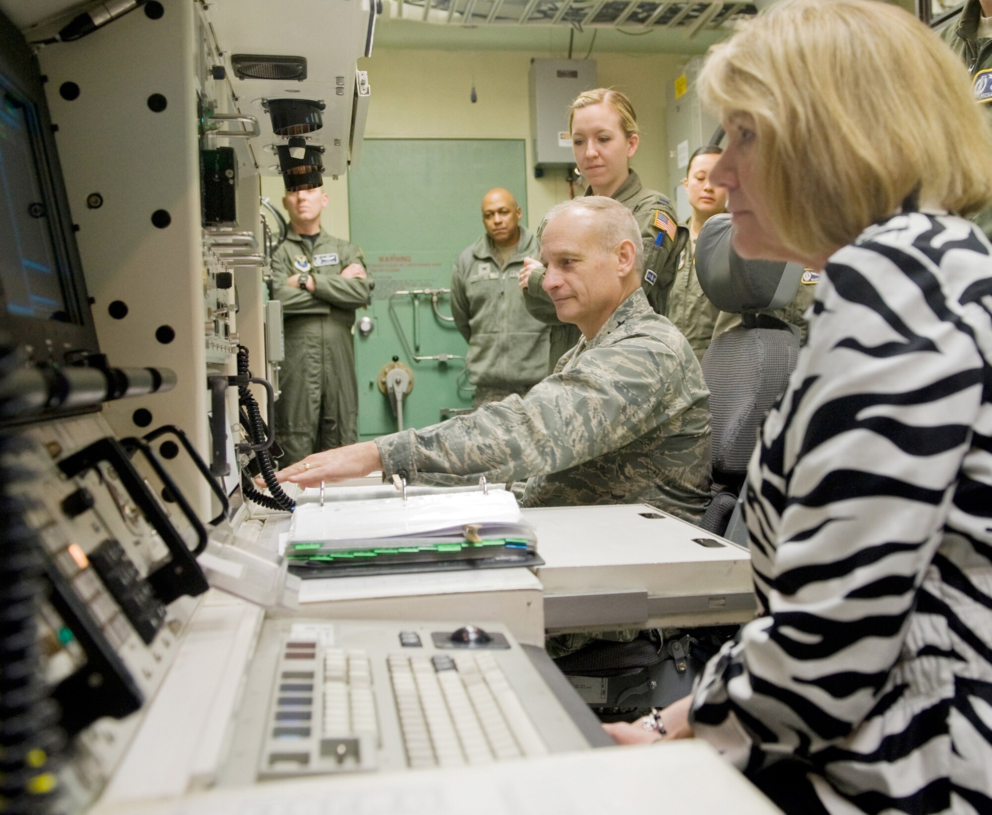 Lt. Gen. James Kowalski, Air Force Global Strike Command commander, and his wife, Julie, operate the console in the missile procedures trainer April 27 under the guidance of 1Lts. Stephanie Stratus and Jen Friedel while 341st Operations Group commander Col. Ed Rimback and 341st Missile Wing Commander Brig. Gen. (Sel) Anthony Cotton, look on. (U.S. Air Force photo/Beau Wade)