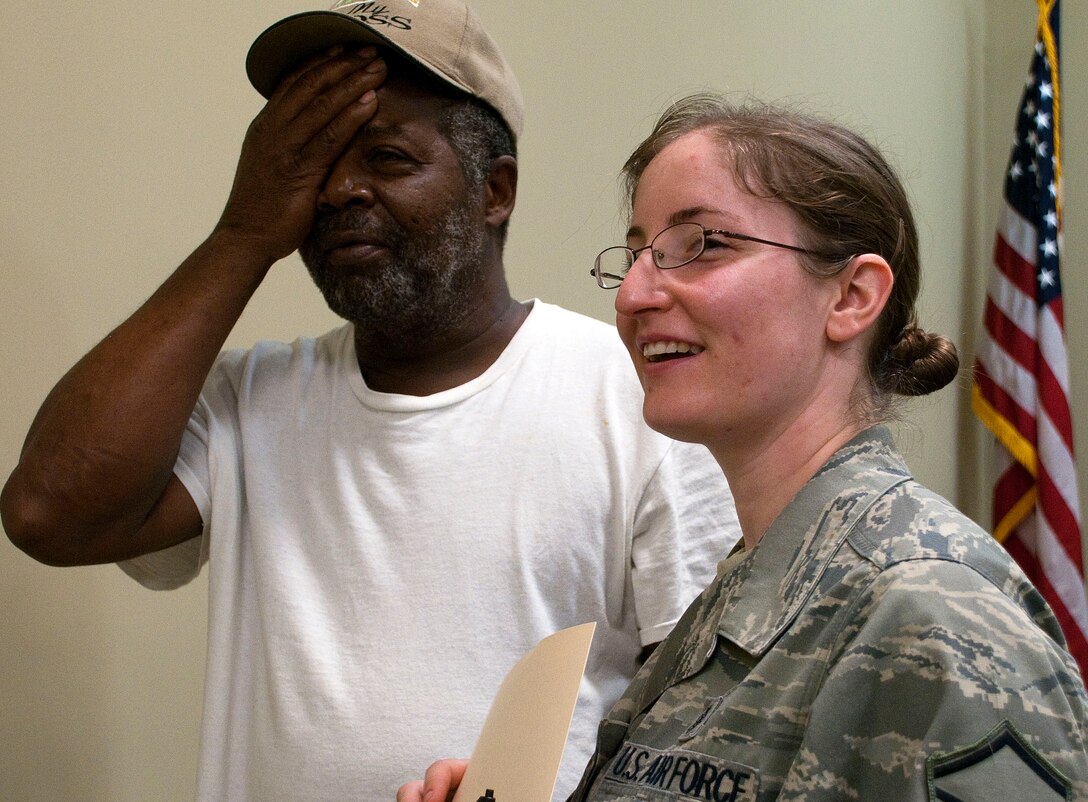 HAYNEVILLE, Ala. -- Master Sgt. Jessica Alvarez, a medical technician with the Alaska Air National Guard's 176th Medical Group, assists an area resident with a vision test at a free medical clinic here May 3, 2011. Twenty-five members of the medical group (together with 10 support personnel from other Alaska Air Guard units) arrived here May 1 for 12 days of training through the Innovative Readiness Program. This program allows Guard and Reserve members to get the training they need while at the same time delivering real-world results -- in this case, providing an array of health-care services to a historically underserved area. Alaska Air National Guard photo by Capt. John Callahan.