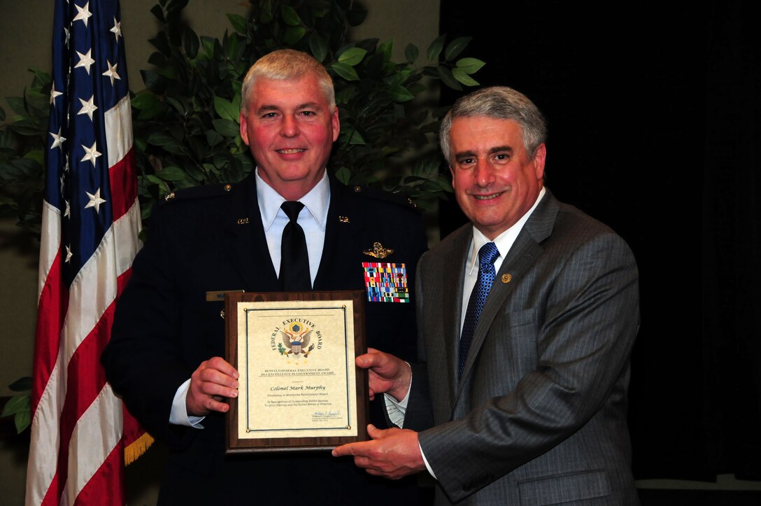BUFFALO, N.Y.- Colonel Mark Murphy, 914th Airlift Wing vice commander, was presented with the Excellence in Workforce Development Award for his efforts as the 914th AW Chairman of the Human Resources Development Council from Mr. William E. Leggiero, Jr., Buffalo Federal Executive Board Chairman. The Excellence in Government Awards Ceremony was held at the Buffalo Convention Center.  The 914th Airlift Wing was among many  other federal agencies represented at the ceremony. The wing had seven members win in six different categories. (U.S. Air Force Reserve photo by Peter Borys)