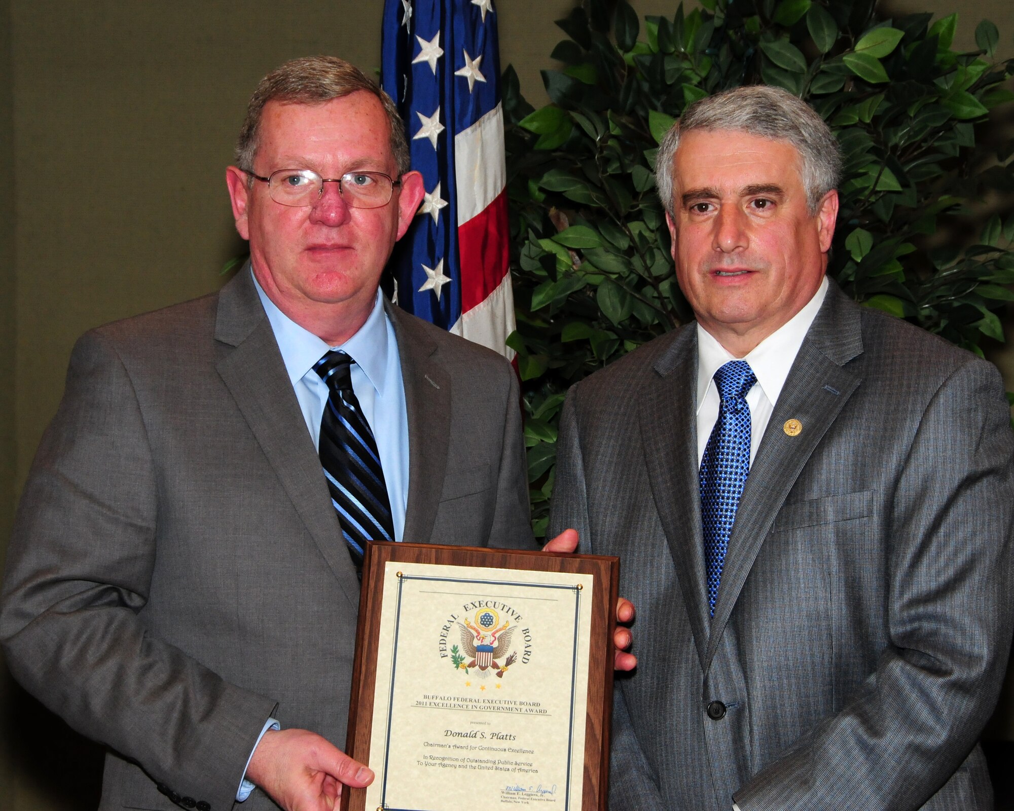 BUFFALO, N.Y.- Chief Master Sergeant (retired) Don Platts (left), is presented with the Chairman's Award for Continuous Excellence from William E. Leggiero, Jr., chairman, Buffalo Federal Executive Board for his leadership, professionalism and ceaseless efforts which directly impacted the success of the Wing's Aeromedical Evacuation mission. The award ceremony was held at the Buffalo Convention Center.  The 914th Airlift Wing was among many  other federal agencies represented at the ceremony. The wing had seven members win in six different categories. (U.S. Air Force Reserve photo by Peter Borys)