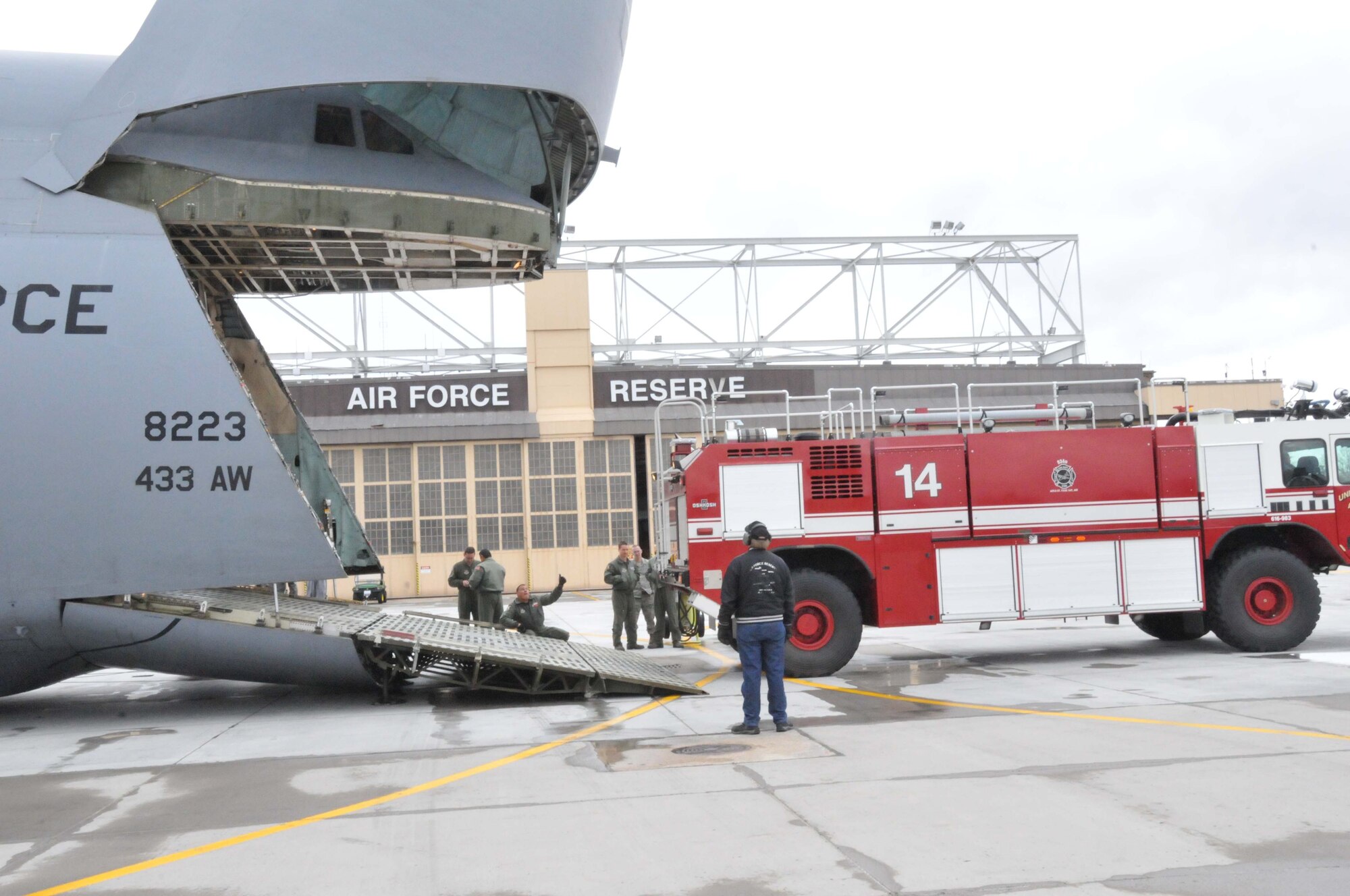 Members of the 27th Aerial Port Squadron load fire trucks on to a C-5 Galaxy for transport to Global Medic at March AFB, Calif. April 28. (Air Force Photo/Paul Zadach)