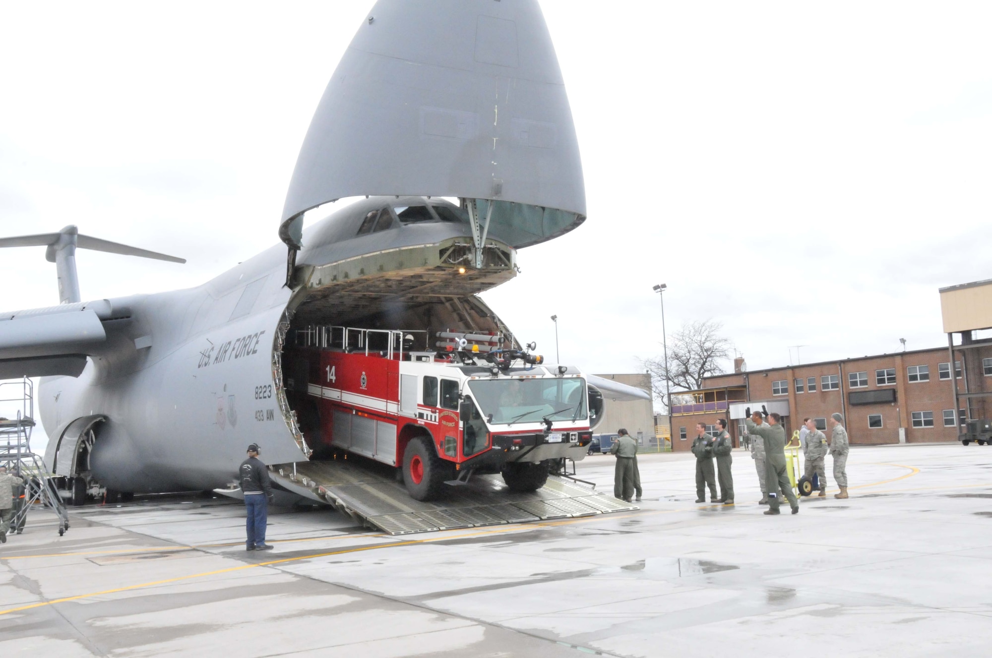 Members of the 27th Aerial Port Squadron load fire trucks on to a C-5 Galaxy for transport to Global Medic at March AFB, Calif. April 28. (Air Force Photo/Paul Zadach)