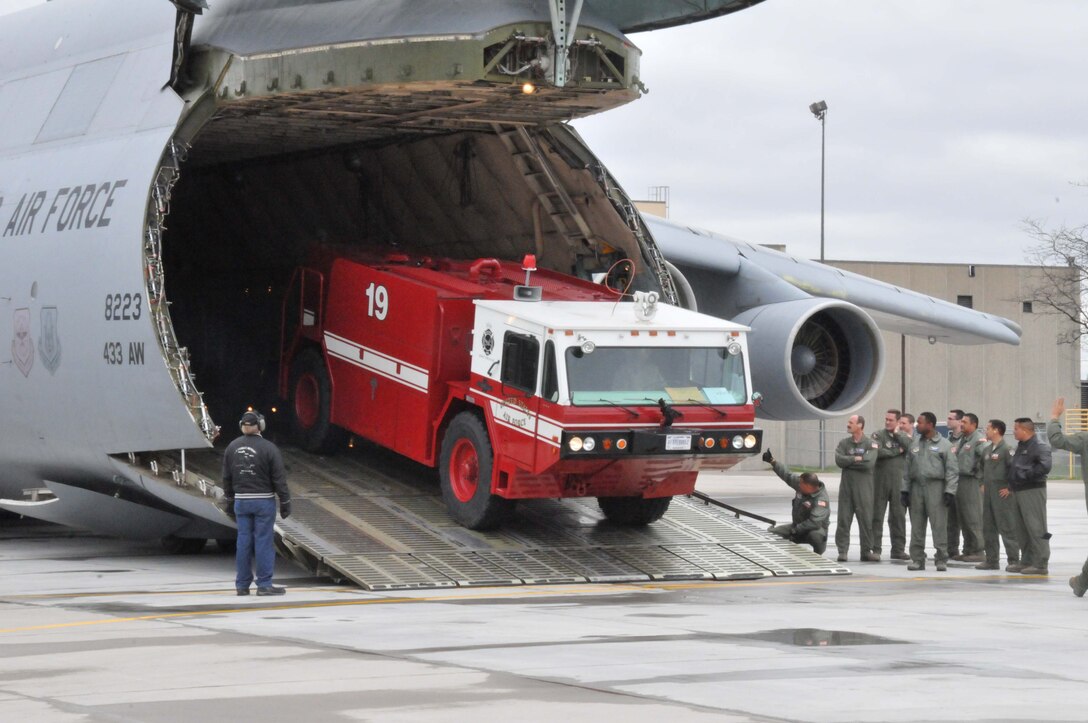 Members of the 27th Aerial Port Squadron load fire trucks on to a C-5 Galaxy for transport to Global Medic at March AFB, Calif. April 28. (Air Force Photo/Paul Zadach)
