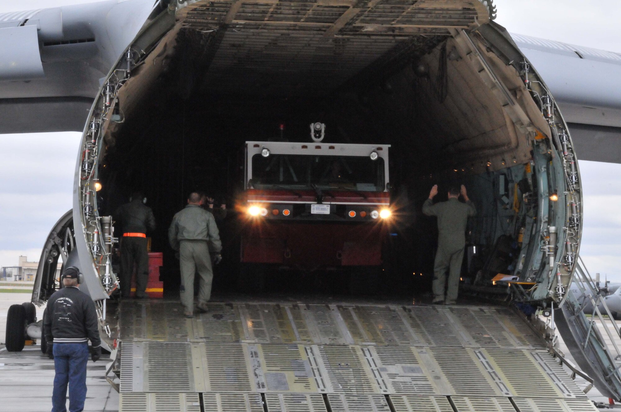 Members of the 27th Aerial Port Squadron load fire trucks on to a C-5 Galaxy for transport to Global Medic at March AFB, Calif. April 28. (Air Force Photo/Paul Zadach)