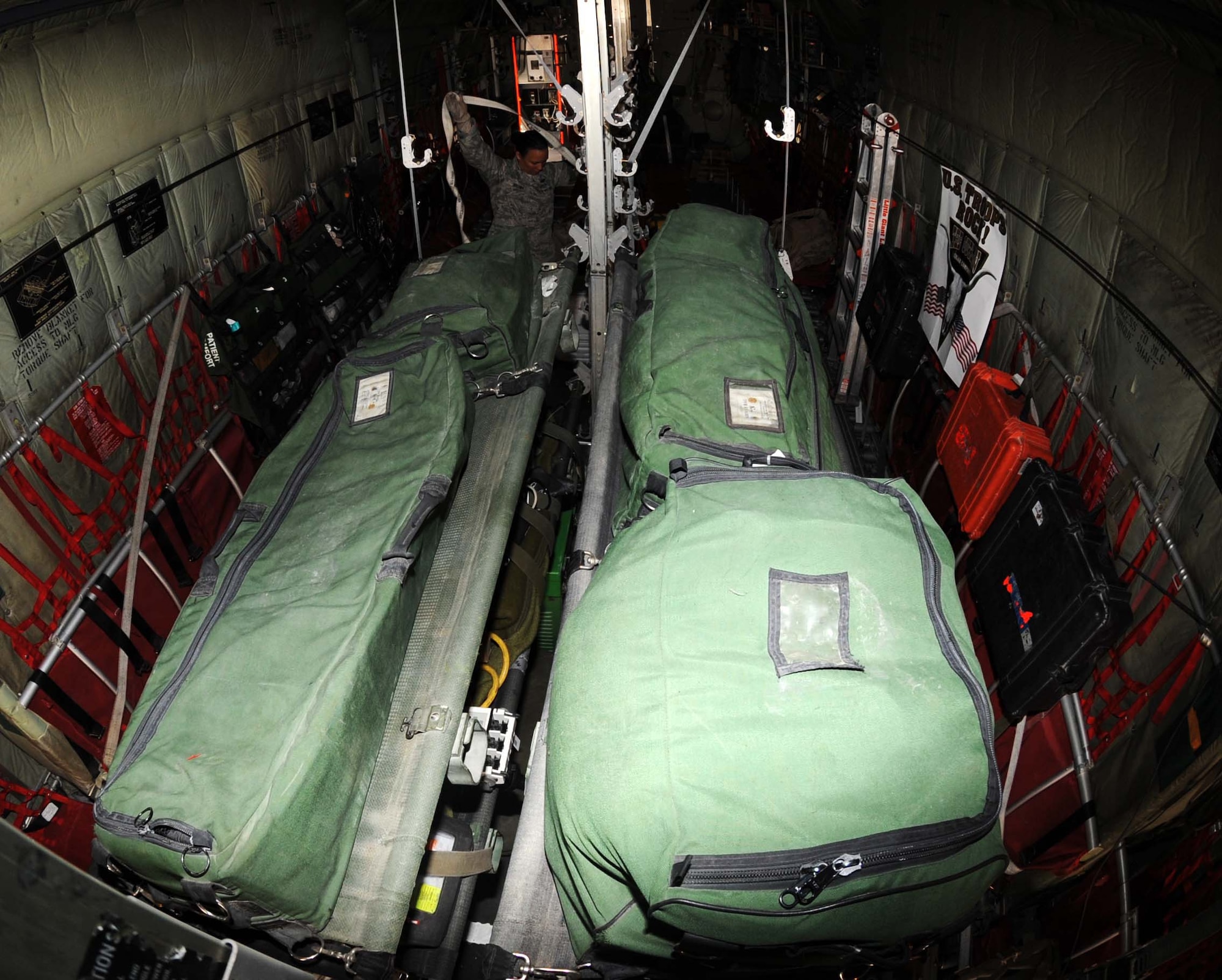 Master Sgt. Carie Brown from the 379 Expeditionary Aeromedical Evacuation Squadron ties down a strap in preperation for flight May 4 in Southwest Asia.  Sergeant Brown and other memebers make set up litters and other equipment prior to the crew's arrival. (U.S. Air Force photo/ Staff Sgt. Anthony Graham)