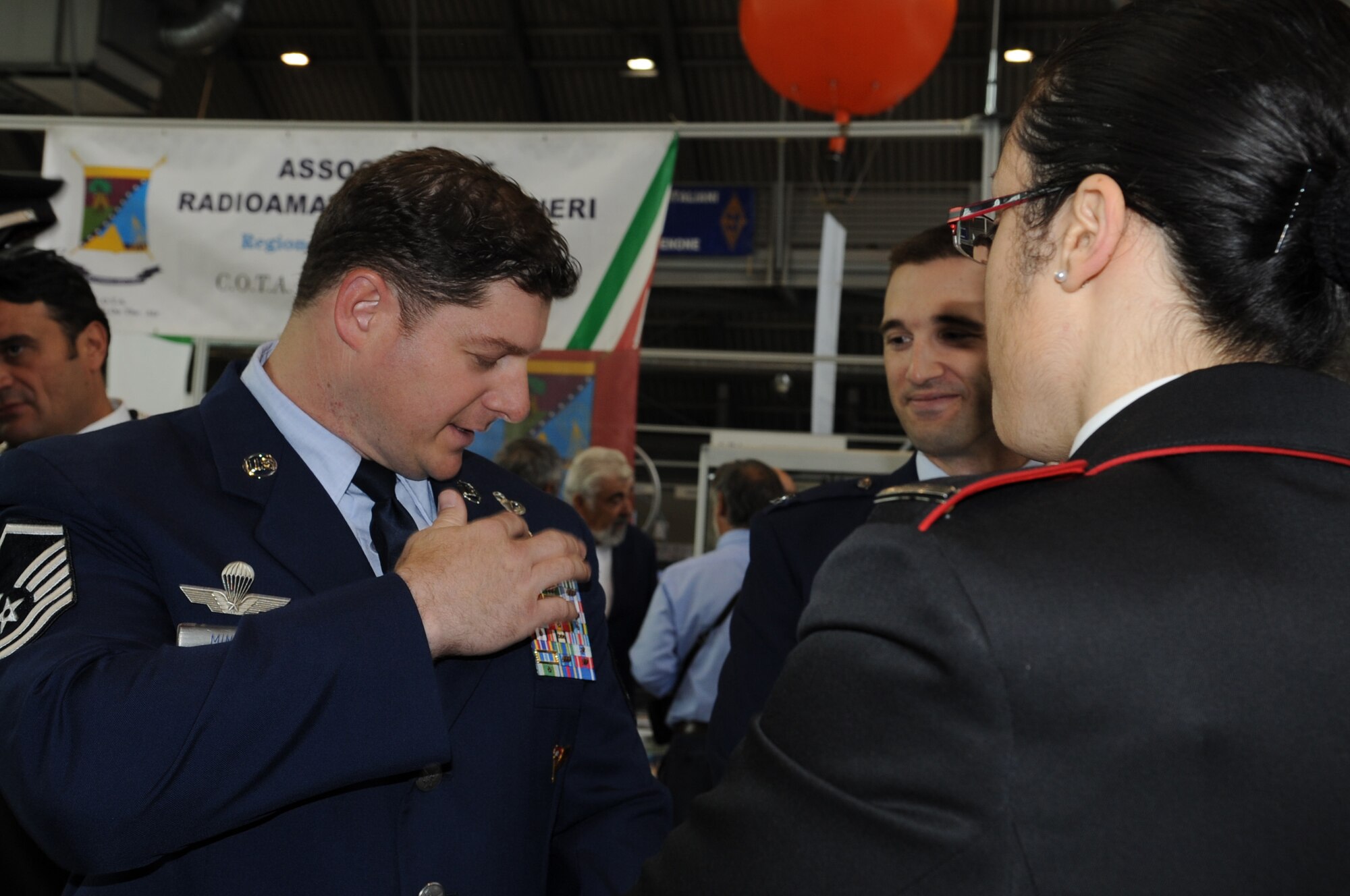 Master Sgt. Shawn Minyon, 8th Air Support Operations Squadron superintendent, explains the difference and importance of U.S. Air Force ribbons to a member of the Italian Carabinieri during the Pordenone Electronics Expo April 29.  Aviano Airmen participated to continue to develop positive communication between the two military cultures and the local community. (U.S. Air Force photo/ Staff Sgt. Nadine Y. Barclay)