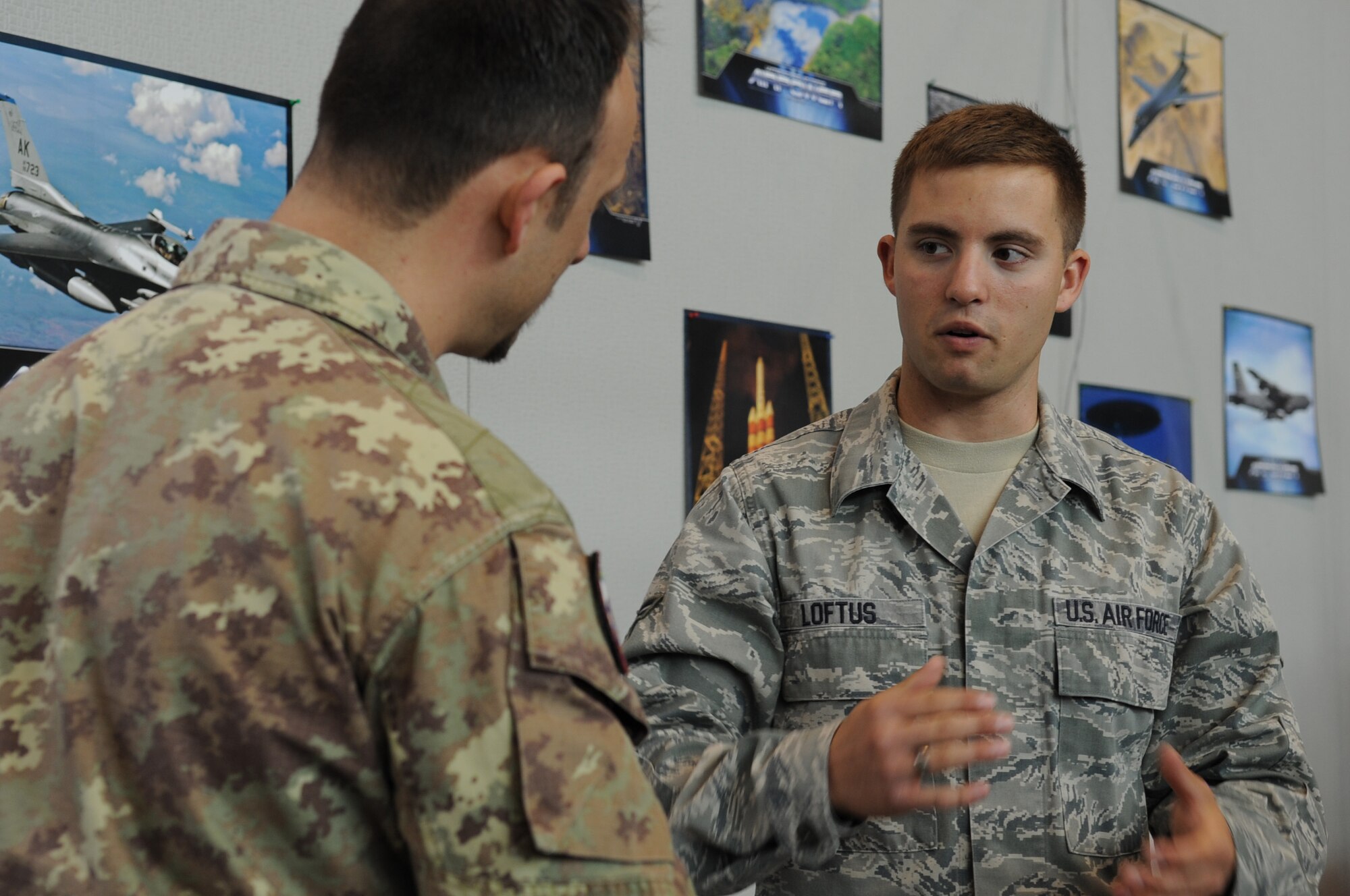 Airman 1st Class Johnathan Loftus, 31st Communications Squadron airfield systems journeyman, discusses the communications aspect of the 31st Fighter Wing mission with an Italian Army member during the Pordenone Electronic Expo, April 29.  Aviano Airmen participated to continue to develop positive communication between the two military cultures and the local community. (U.S. Air Force photo/ Staff Sgt. Nadine Y. Barclay)