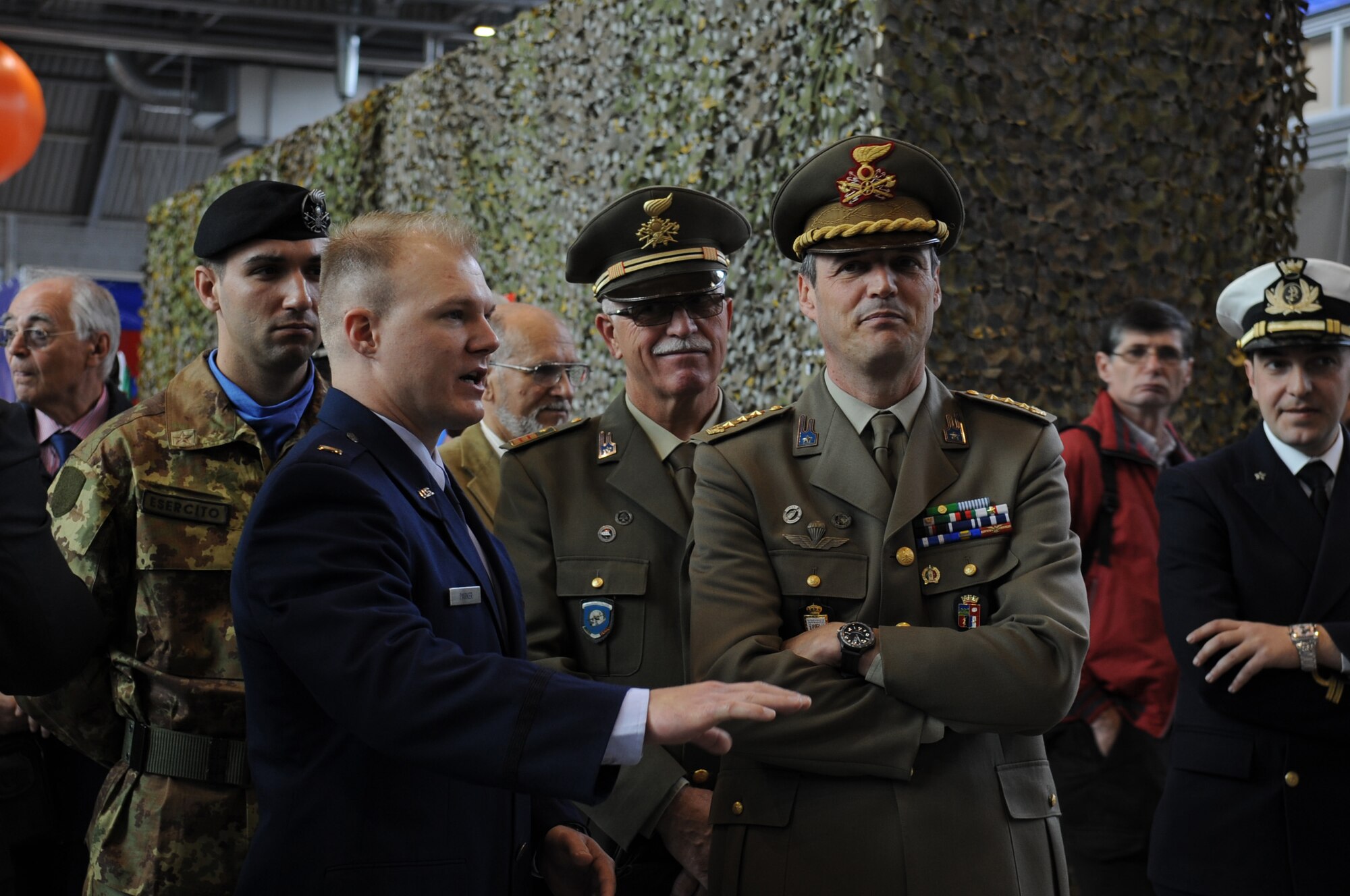 Second Lt. Wesley Parker, 31st Communications Squadron officer in charge of post and unit deployments, briefs Italian Army personnel about the communication capabilities used in current operations during the Pordenone Electronics Expo April 29. Aviano Airmen participated to continue to develop positive communication between the two military cultures and the local community. (U.S. Air Force photo/ Staff Sgt. Nadine Y. Barclay)
