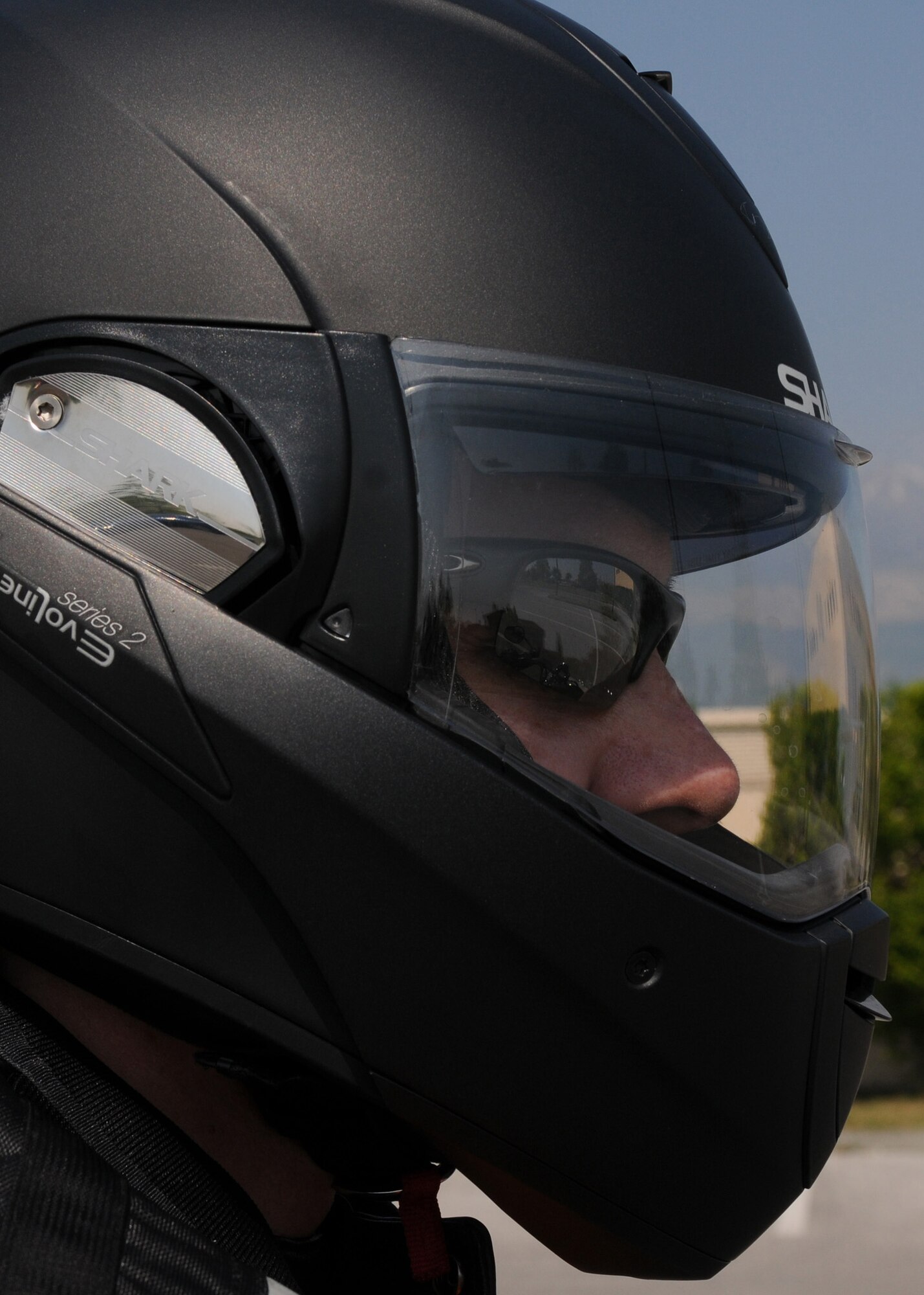 Tech. Sgt. Jason Smith, 31st Fighter Wing motorcycle safety program manager, demonstrates the proper protective gear required by Air Force Instruction 91-207 when operating a motorcycle. Protective eye wear, approved motorcycle safety foundation helmet, gloves, closed-toe shoes and brightly colored reflective clothing are all required items when operating a motorcycle on or off base.   (U.S. Air Force photo/ Staff Sgt. Nadine Y. Barclay)
