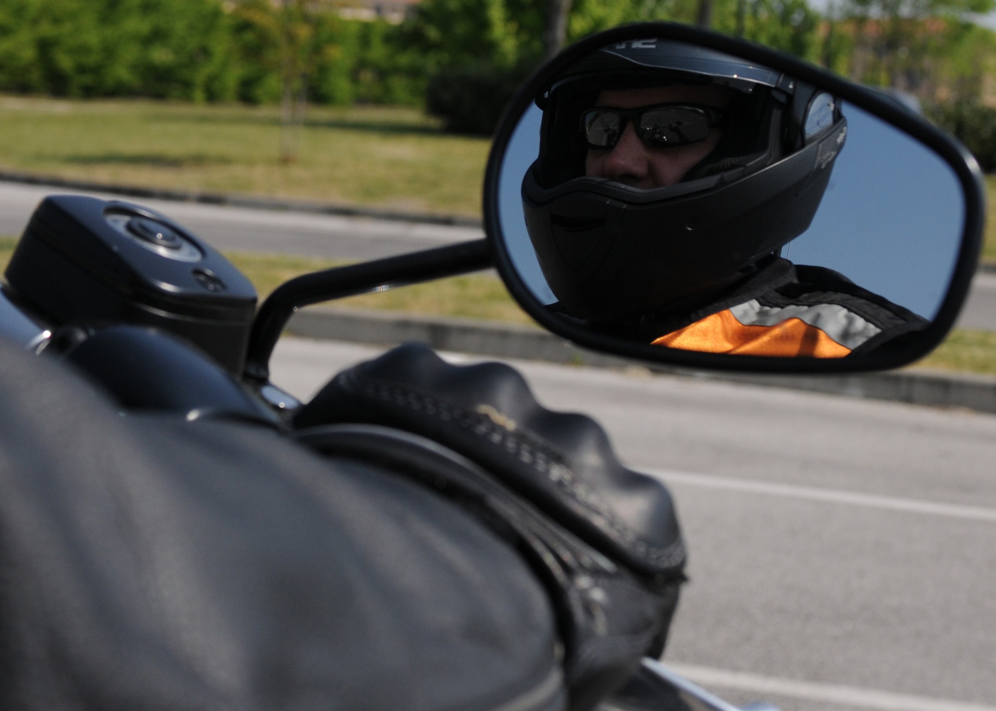 Tech. Sgt. Jason Smith, 31st Fighter Wing motorcycle safety program manager, demonstrates the proper protective gear required by Air Force Instruction 91-207 when operating a motorcycle. Protective eye wear, approved motorcycle safety foundation helmet, gloves, closed-toe shoes and brightly colored reflective clothing are all required items when operating a motorcycle on or off base.  (U.S. Air Force photo/ Staff Sgt. Nadine Y. Barclay)
