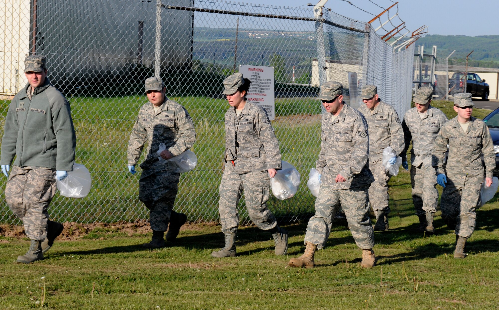 SPANGDAHLEM AIR BASE, Germany – Airmen from the 52nd Fighter Wing search for foreign object debris after the 2011 Spring Bazaar here May 2. The clean-up took place to prevent FOD from getting on the flightline and taxiways and potentially damaging aircraft. (U.S. Air Force photo/Airman 1st Class Brittney Frees)