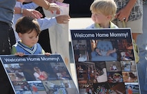 Two young family members eagerly wait on the 916th Air Refueling Wing ramp for their mother's return from a recent deployment. Airmen from the 77th Air Refueling Squadron, 911th Air Refueling Squadron, 916th Maintenance Group and 916th Mission Support Group returned home this week. (USAF photo by Ms. Donna Lea, 916ARW/PA)