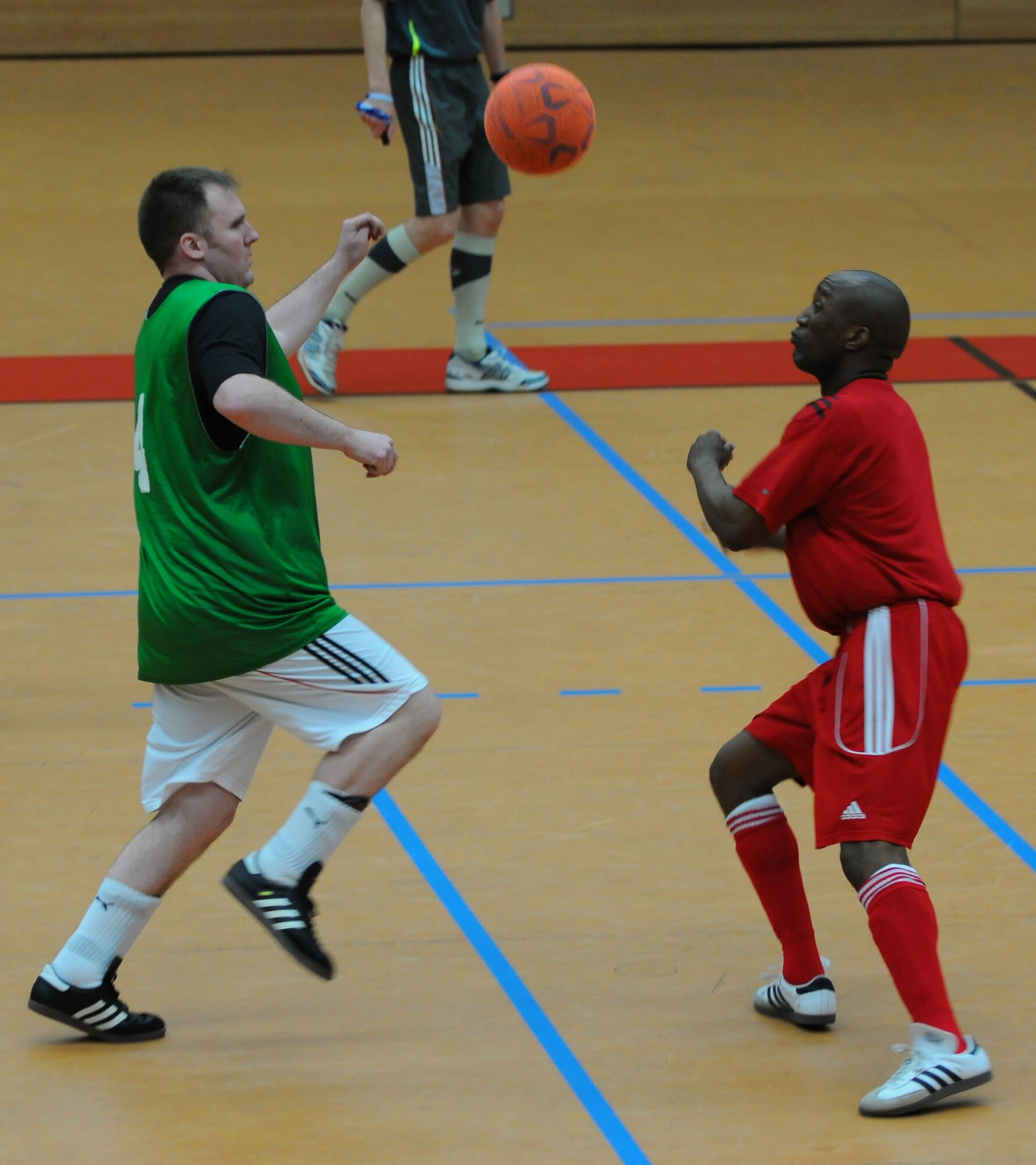 SPANGDAHLEM AIR BASE, Germany –Kent Spitler, left, 52nd Civil Engineer Squadron, and Alfred Doby, 52nd Aerospace Medicine Squadron, compete for control of a falling soccer ball during an intramural soccer game at the Skelton Memorial Fitness Center here April 28. The 52nd CES defeated the 52nd Medical Group 6-2. (U.S. Air Force photo/Airman 1st Class Dillon Davis)