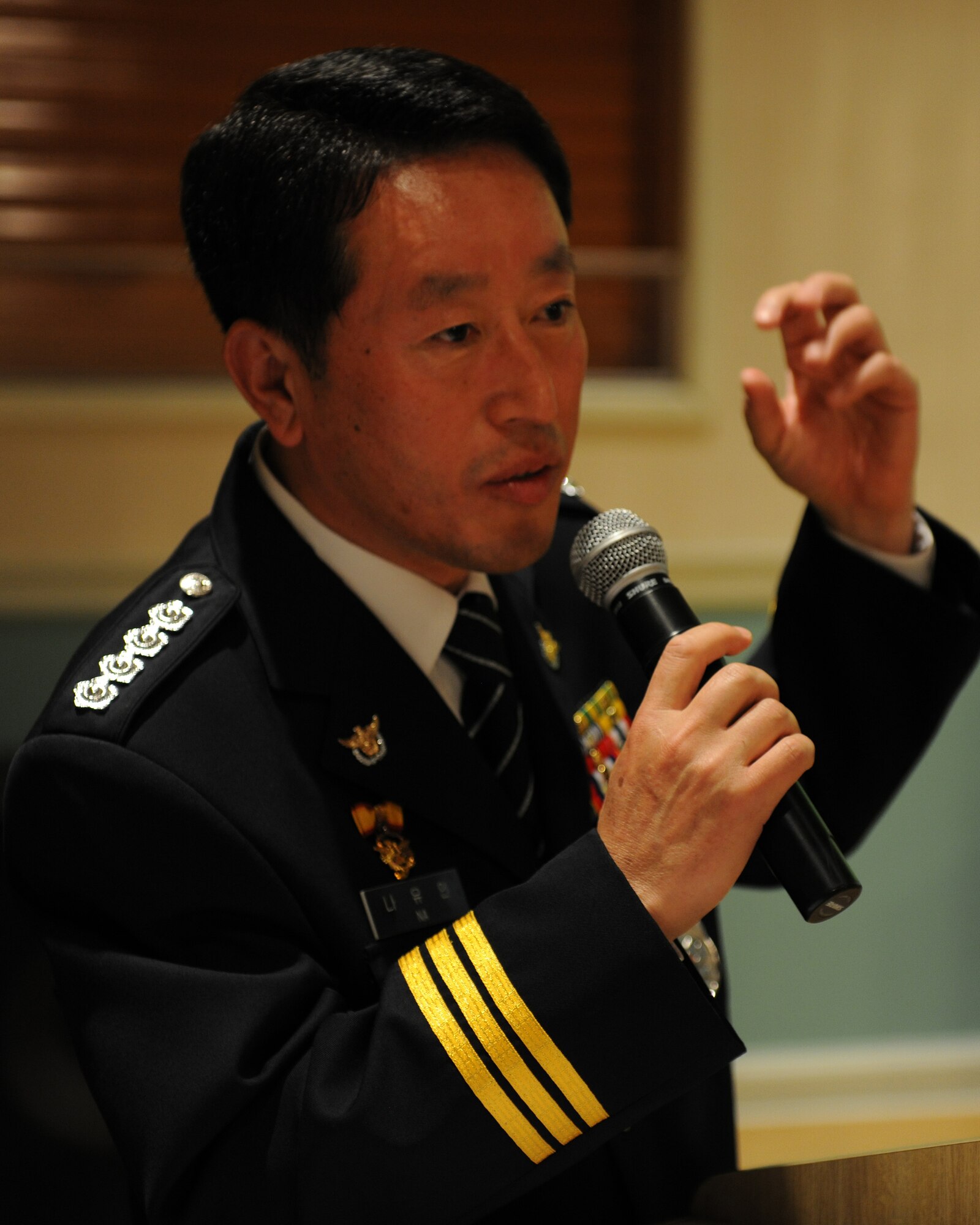 KUNSAN AIR BASE, Republic of Korea -- Chief Na Yu-In, Gunsan Korean National Police chief, addresses 8th Security Forces Squadron Airmen following a lunch at the Loring Club here May 3. Chief Na and Lt. Col. Mark Anarumo, 8th SFS commander, planned the event after they met and found a common bond in education, which they realized could benefit both of their forces. Colonel Anarumo plans to address the Gunsan City police in June. (U.S. Air Force photo/Senior Airman Ciara Wymbs)