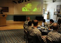 KUNSAN AIR BASE, Republic of Korea -- 8th Security Forces Squadron Airmen watch a video about the Korean National Police during a briefing by Chief Na Yu-In, Gunsan KNP chief, following a lunch at the Loring Club here May 3. Chief Na and Lt. Col. Mark Anarumo, 8th SFS commander, planned the event after they met and found a common bond in education, which they realized could benefit both of their forces. Colonel Anarumo plans to address the Gunsan City police in June. (U.S. Air Force photo/Senior Airman Ciara Wymbs)