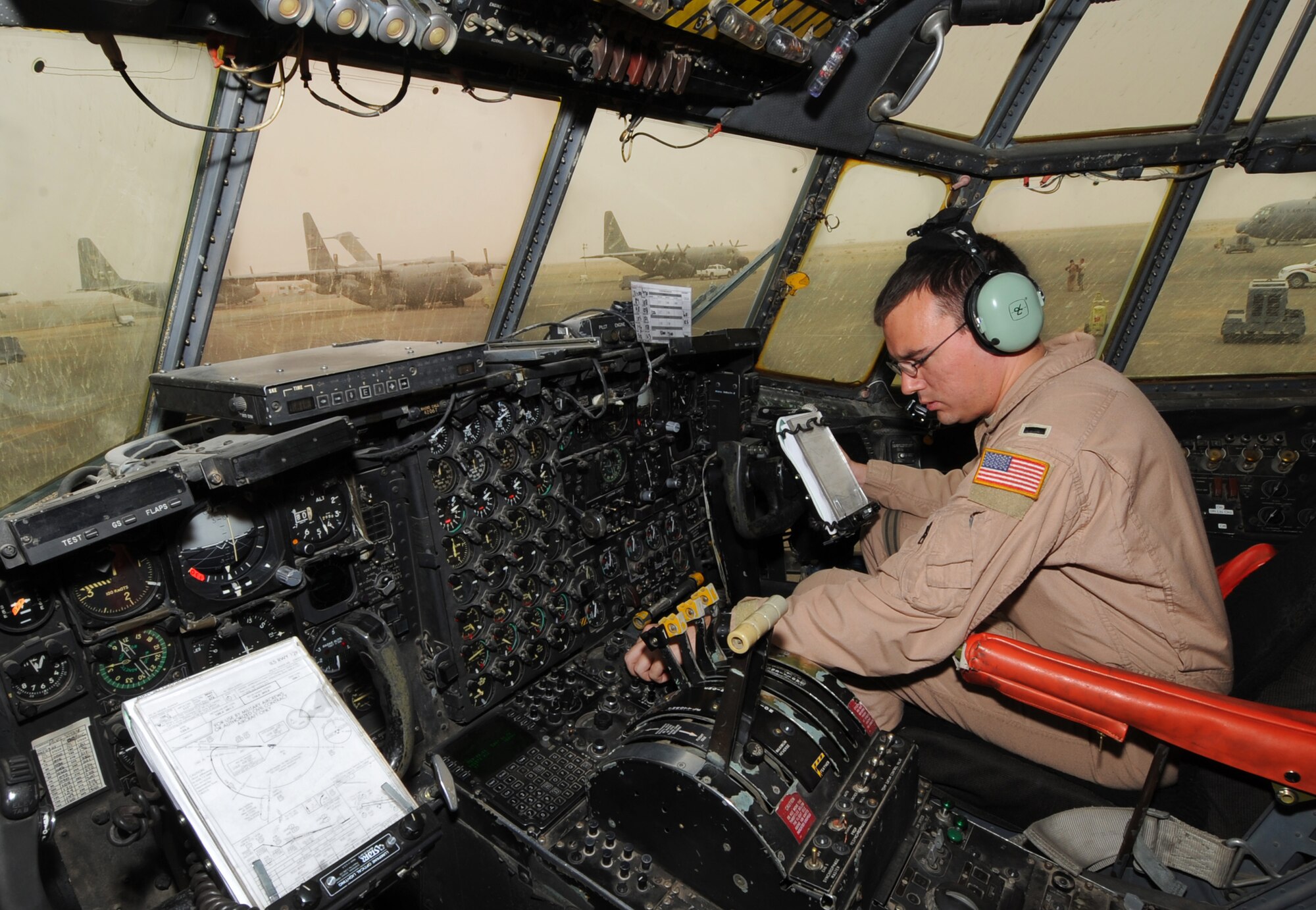 First Lt. Daniel Oldham does pre-flight checks on the flight deck of a C-130 Hercules before takeoff. Lieutenant Oldham is a pilot with the 386th Expeditionary Operations Group. (U.S. Air Force photo by Senior Airman Cynthia Spalding)