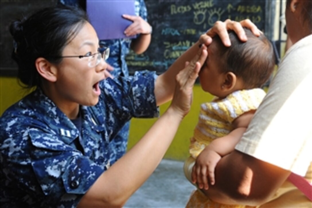 U.S. Navy Lt. Eva Chou, an ophthalmologist, exams the eyes of a 7-month-old patient at a medical clinic at Sagrado Corzon de Jesus School in Paita, Peru, on May 1, 2011.  Chou is part of Continuing Promise 2011, a five-month humanitarian assistance mission to the Caribbean, Central and South America.  
