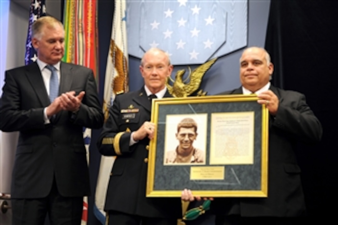 Deputy Secretary of Defense William J. Lynn III applauds as Chief of Staff of the Army Gen. Martin Dempsey presents the Hall of Heroes induction plaque to George Kaho'ohanohano, nephew of Korean War Medal of Honor recipient Army Pfc. Anthony Kaho'ohanohano, during a ceremony at the Pentagon on May 3, 2011.  