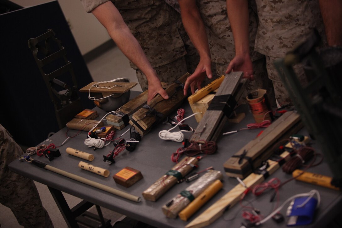 MARINE CORPS BASE CAMP LEJEUNE, N.C. – Marines walk around a table that displays a wide variety of improvised explosive devices, many of which have little to no metal, that are currently being used against service members overseas, during a briefing about the many different courses offered to Marines at the new Home station Training Lanes and the Counter Improvised Explosive Device training facility aboard Marine Corps Base Camp Lejeune, May 5.