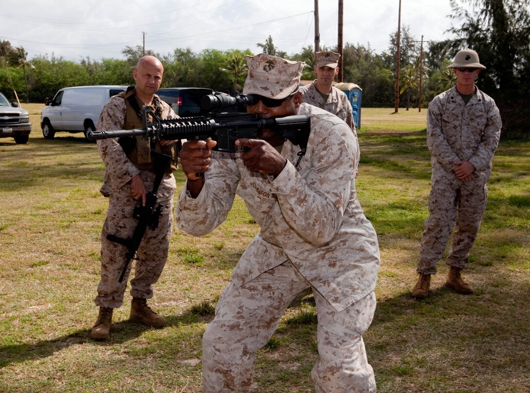 Staff Sgt. Michael A. Johnson, company gunnery sergeant for Headquarters Company, Headquarters and Service Battalion, U.S. Marine Corps Forces, Pacific, demonstrates a proper shooting stance during Table 3 Intermediate Combat Rifle Marksmanship Training with the M4 Carbine assault rifle here. MarForPac Marines began Table 3 qualifications in January as part of a Corps-wide effort to provide Marines additional weapons training. The majority of Marines qualify annually on the Table 1, known distance, and Table 2, field fire, courses of fire.