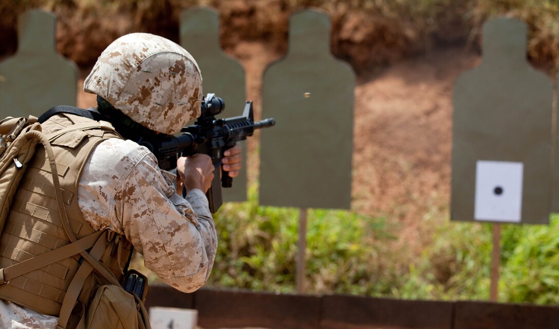 Capt. Marcos Azua, comptroller for Headquarters and Service Battalion, U. S. Marine Corps Forces, Pacific, fires from the five-yard line during Table 3 Intermediate Combat Rifle Marksmanship Training with the M4 Carbine assault rifle May 5 here. MarForPac Marines began Table 3 qualifications in January as part of a Corps-wide effort to provide Marines additional weapons training. The majority of Marines qualify annually on the Table 1, known distance, and Table 2, field fire, courses of fire.