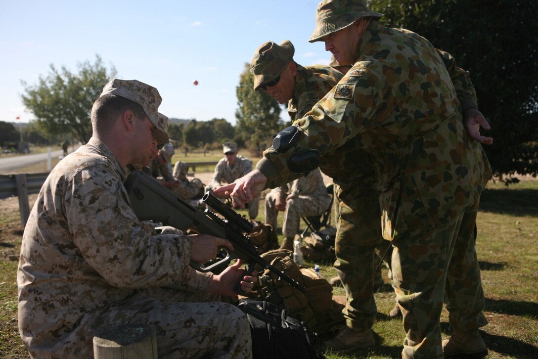 Cpl. Jeremy Notino, armorer, Combat Logistics Regiment 37, 3rd Marine Logistics Group, III Marine Expeditionary Force, looks over an Australian main battle-rifle, the F88 Austry here May 5 as part of the 2011 Australian Army Skill at Arms Meeting. AASAM is an annual, international combat-marksmanship competition hosted by the Australian Army that will run through May 19. (U.S. Marine Corps Photo by Lance Cpl. Mark W. Stroud/Released)